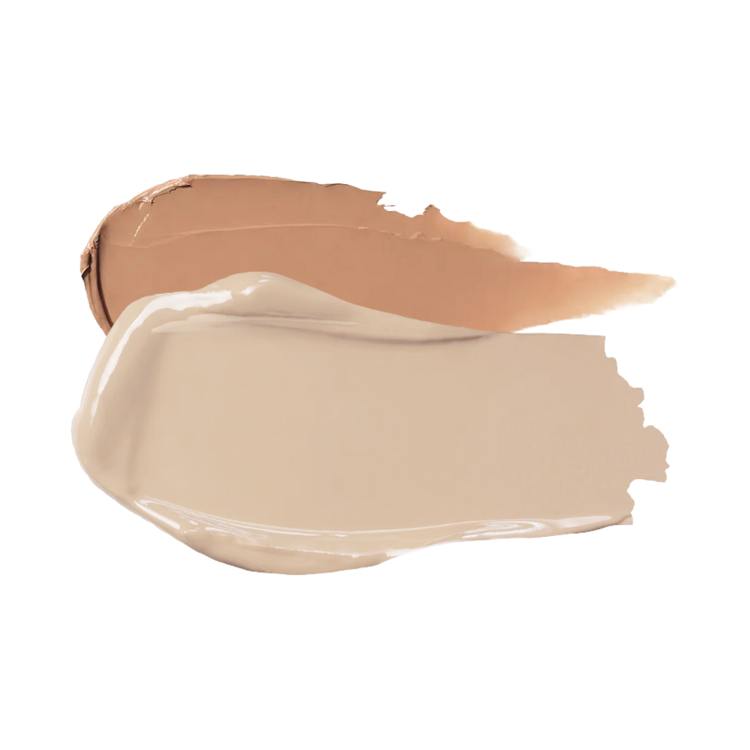 Three swatches of foundation makeup in various shades, stacked on top of each other with a smooth, creamy texture.