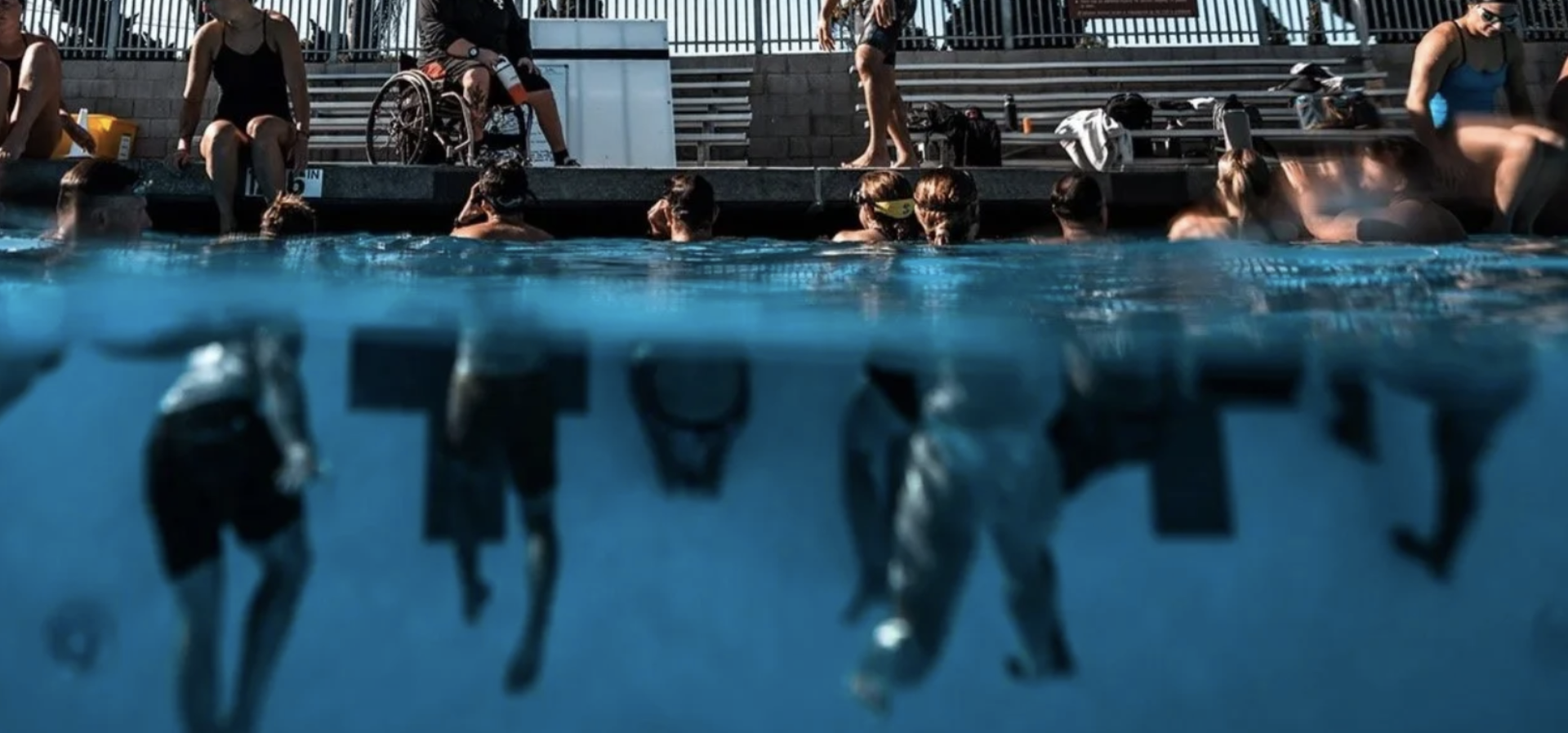 Deep End Fitness athlete wearing grey tee and hat