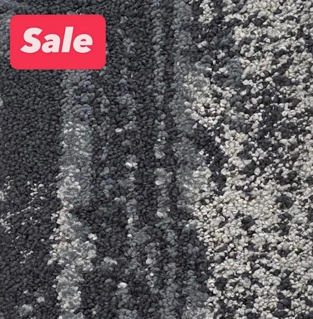 Close-up of a road with black asphalt and white painted lines, showing tire marks.