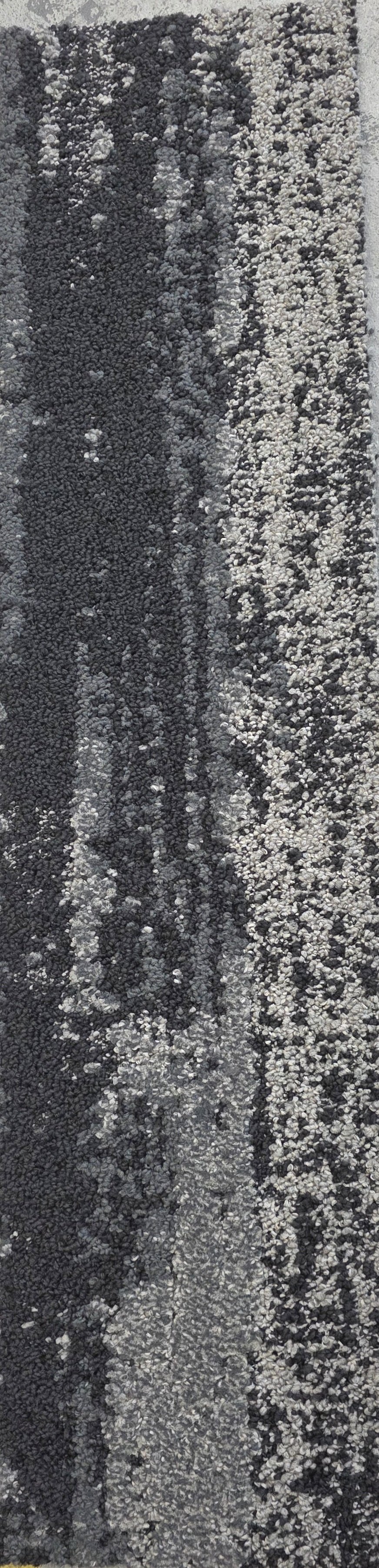 Close-up of a road with black asphalt and white painted lines, showing tire marks.