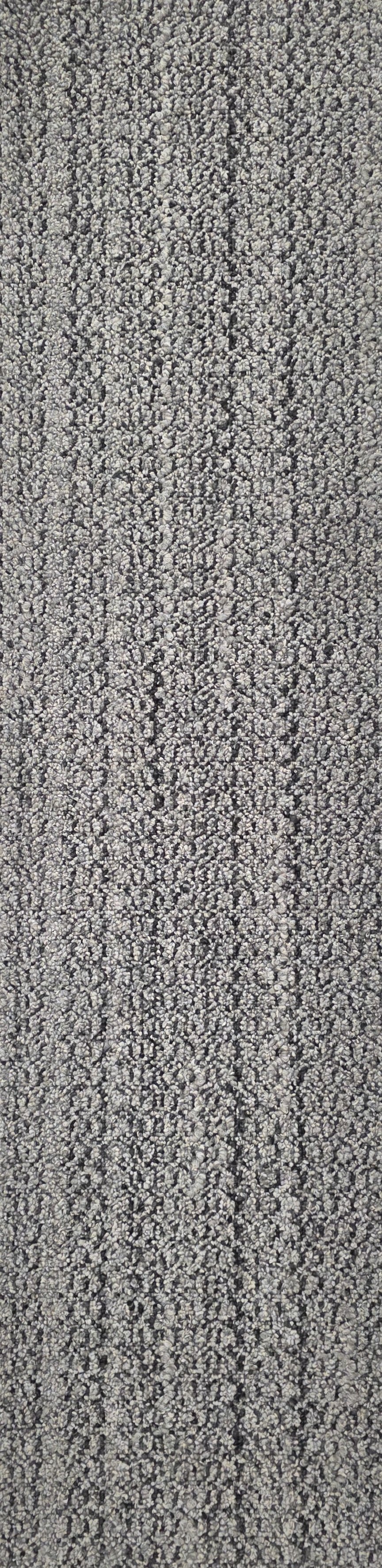 Close-up view of a textured gray carpet with a dense pattern of small loops.
