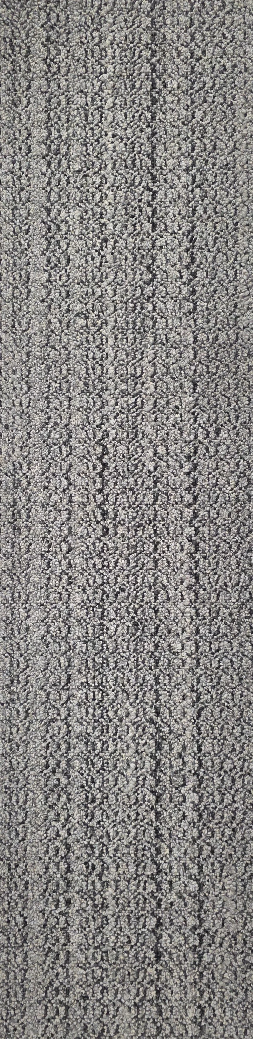 Close-up view of a textured gray carpet with a dense pattern of small loops.