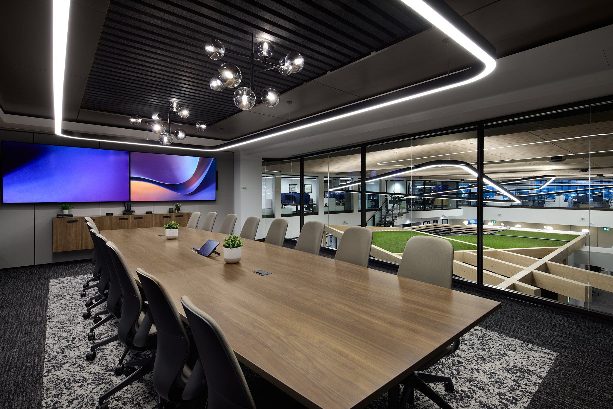 Modern corporate boardroom interior at Navacord Insurance in Edmonton featuring open to below meeting space