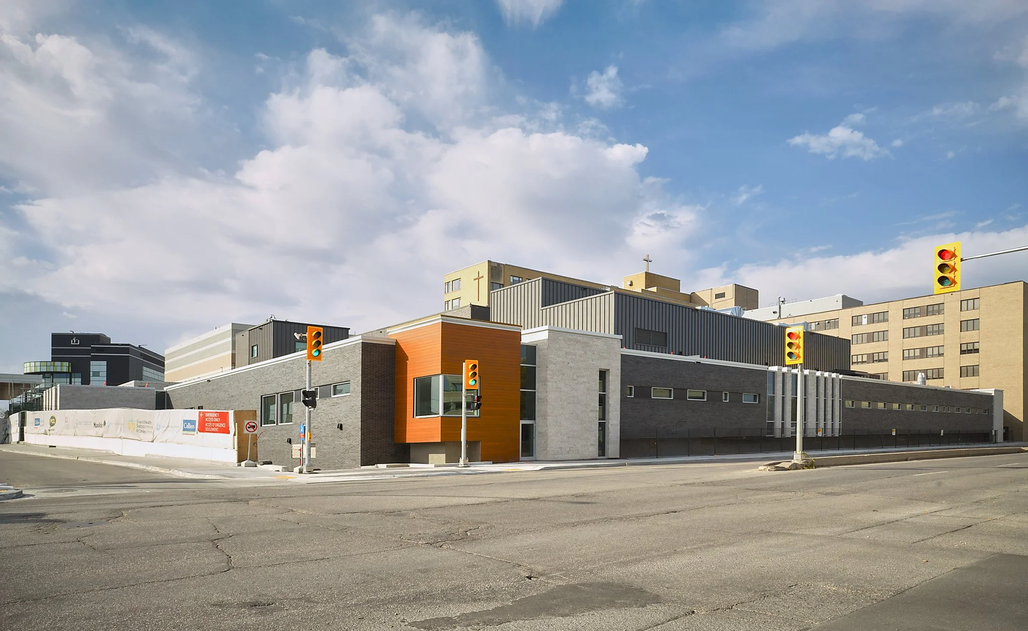St. Boniface Hospital exterior in Winnipeg during major mechanical and infrastructure upgrades – featuring construction of the new Emergency Department and Hybrid OR/IR suite, photographed to capture scale, design, and complex building systems while 