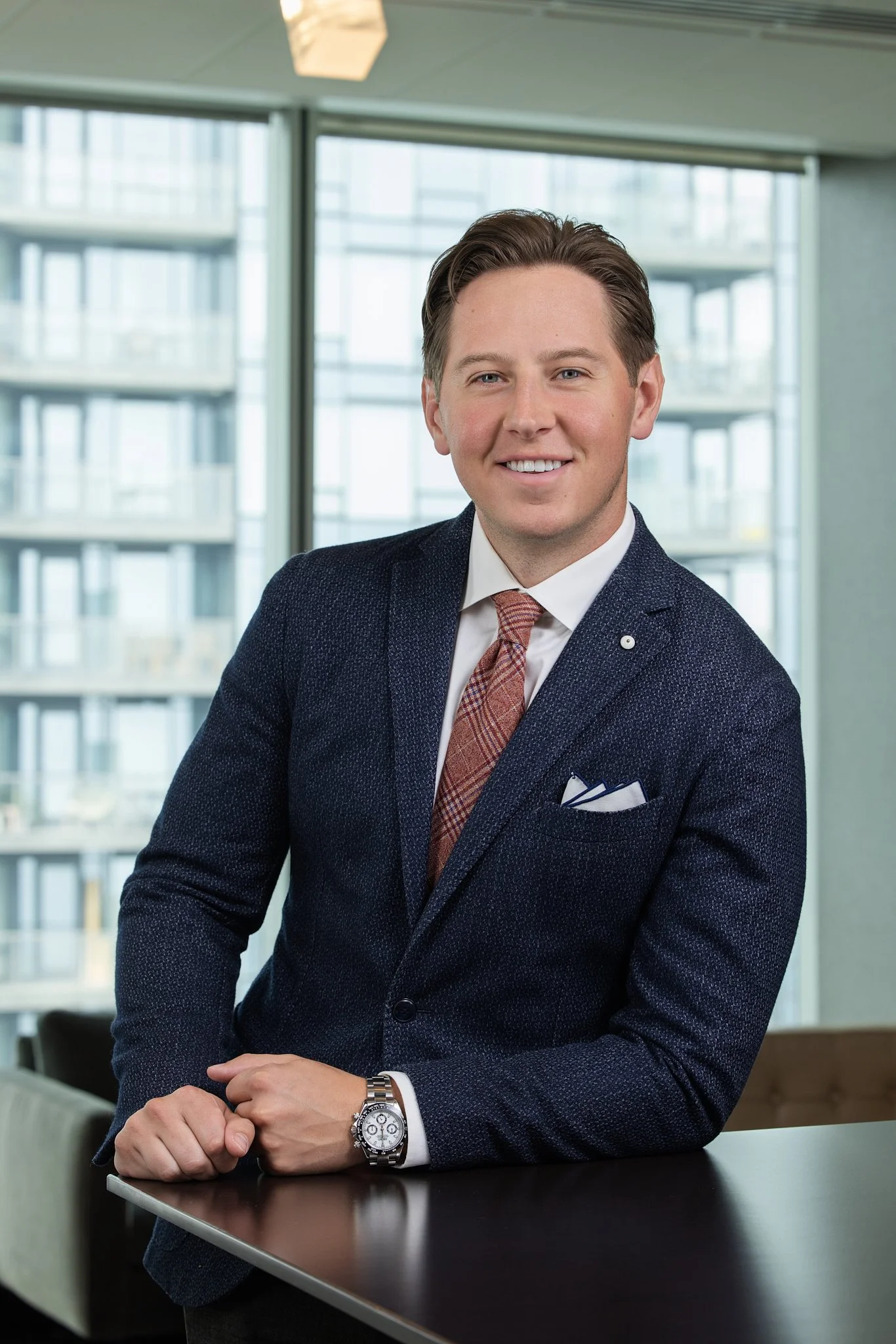 Man in suite posing by a table top in Edmonton