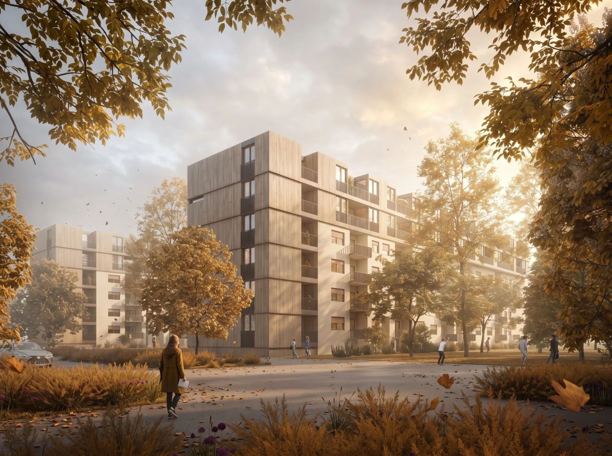 Modern apartment building surrounded by trees with autumn leaves, people walking and gathering outside, cars parked in the background, in a suburban area during daytime with soft sunlight.