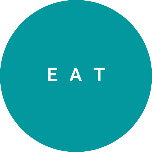 A teal circular sign with the word 'EAT' in white, uppercase letters.