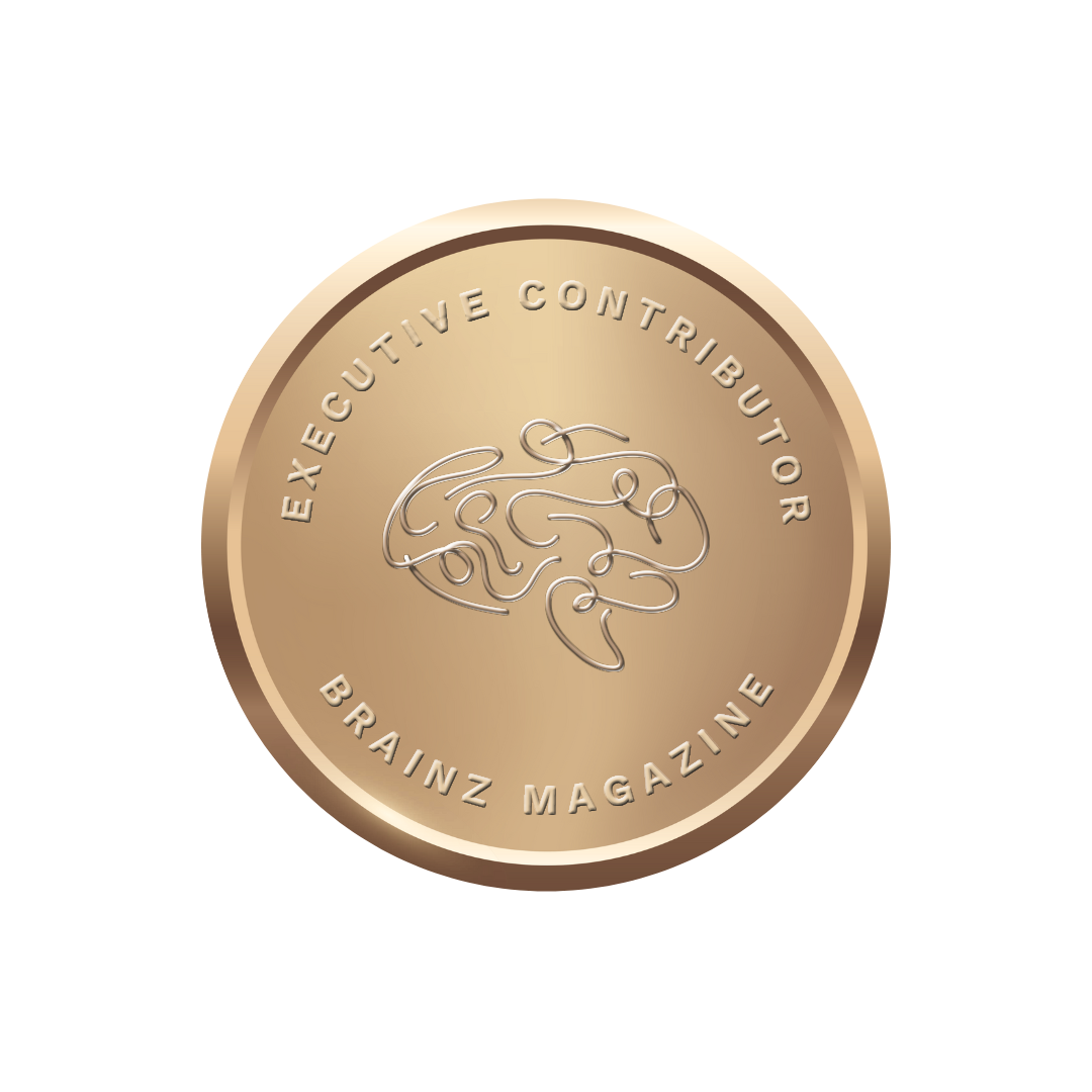 A bronze-colored coin with the text 'EXEutive Contributor BRAiNZ MAGAZINE' and a stylized line drawing of a brain in the center.