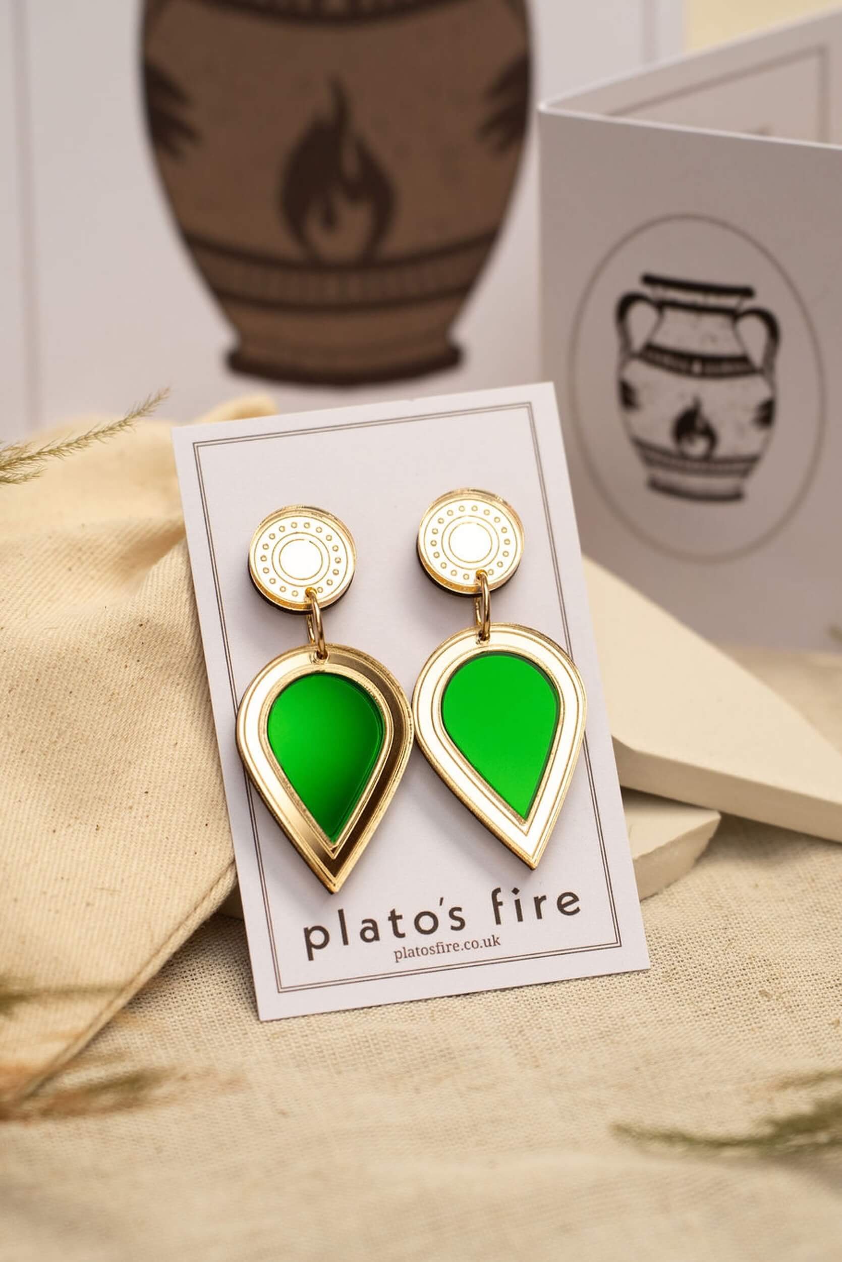 laser-cut acrylic teardrop drop stud earrings in mirror gold and emerald green on a backing card