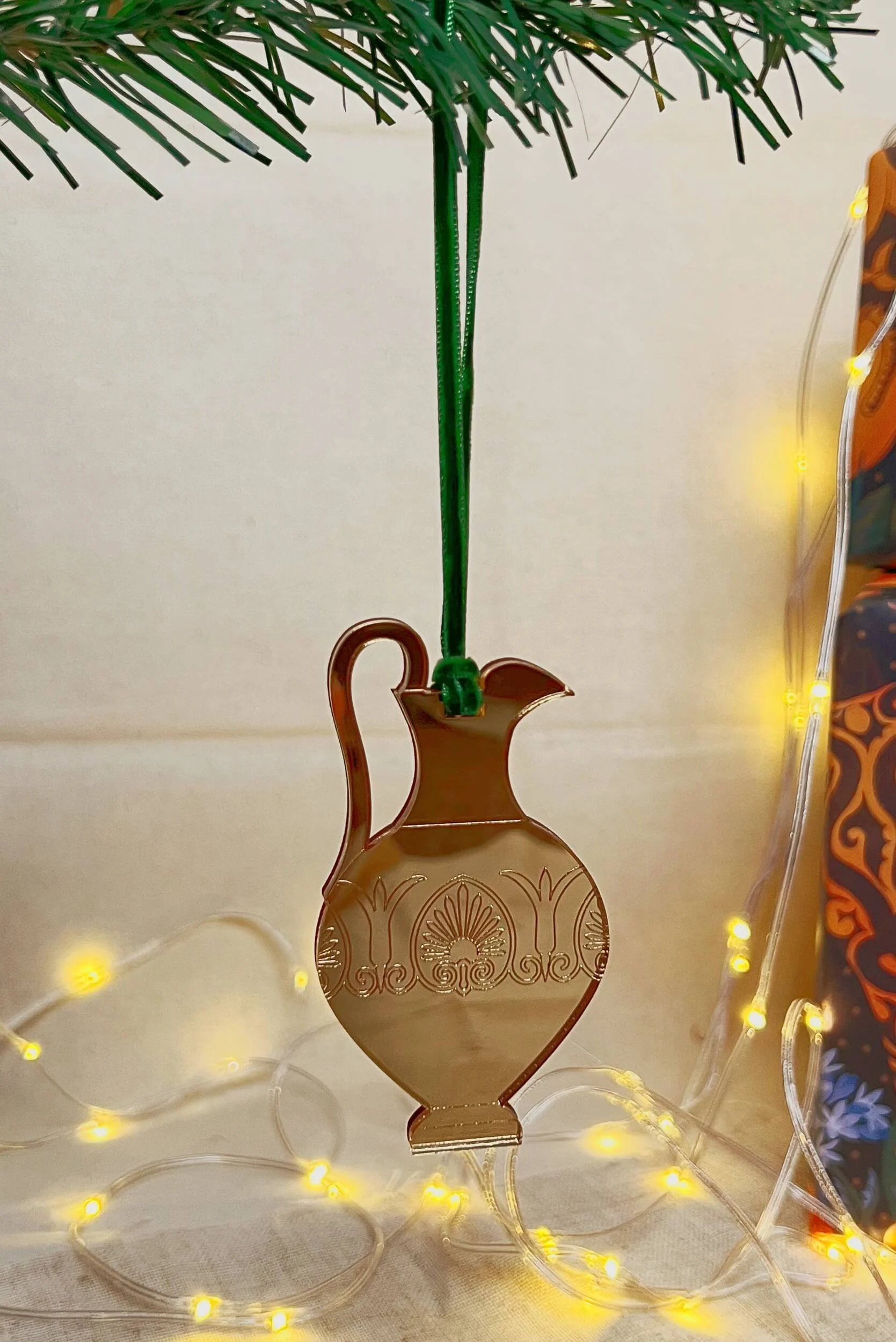 ancient greek oinochoe vase christmas tree ornament in gold mirror acrylic hanging from green velvet ribbon