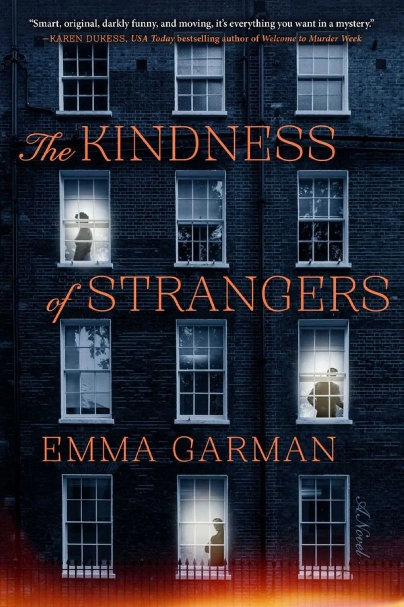 The cover of a book titled "The Kindness of Strangers" by Emma Garman. The background is a dark brick building with several windows, some of which are lit. Silhouettes of people can be seen through the windows, creating a mysterious and intriguing atmosphere.