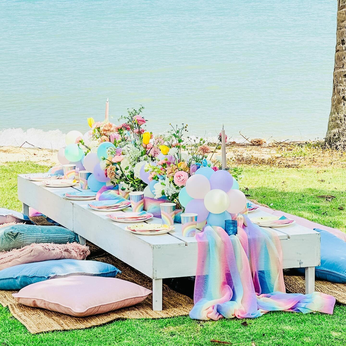 We&rsquo;re excited to feature here one of our idyllic outdoor picnic setups! Picture whitewashed low picnic tables adorned with charming garden-themed florals and plush cushions, creating an inviting space for your gathering. With the perfect weathe