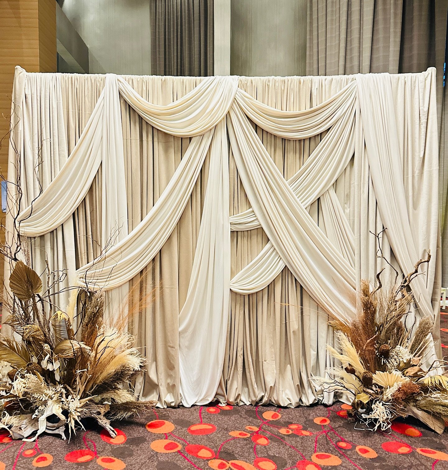 Experience a modern twist on fabric draping that goes beyond the traditional pipe-and-drape! Our custom designs blend elegance and creativity, bringing a sophisticated flair to your event with stunning drapes and curated floral arrangements.

Let&rsq