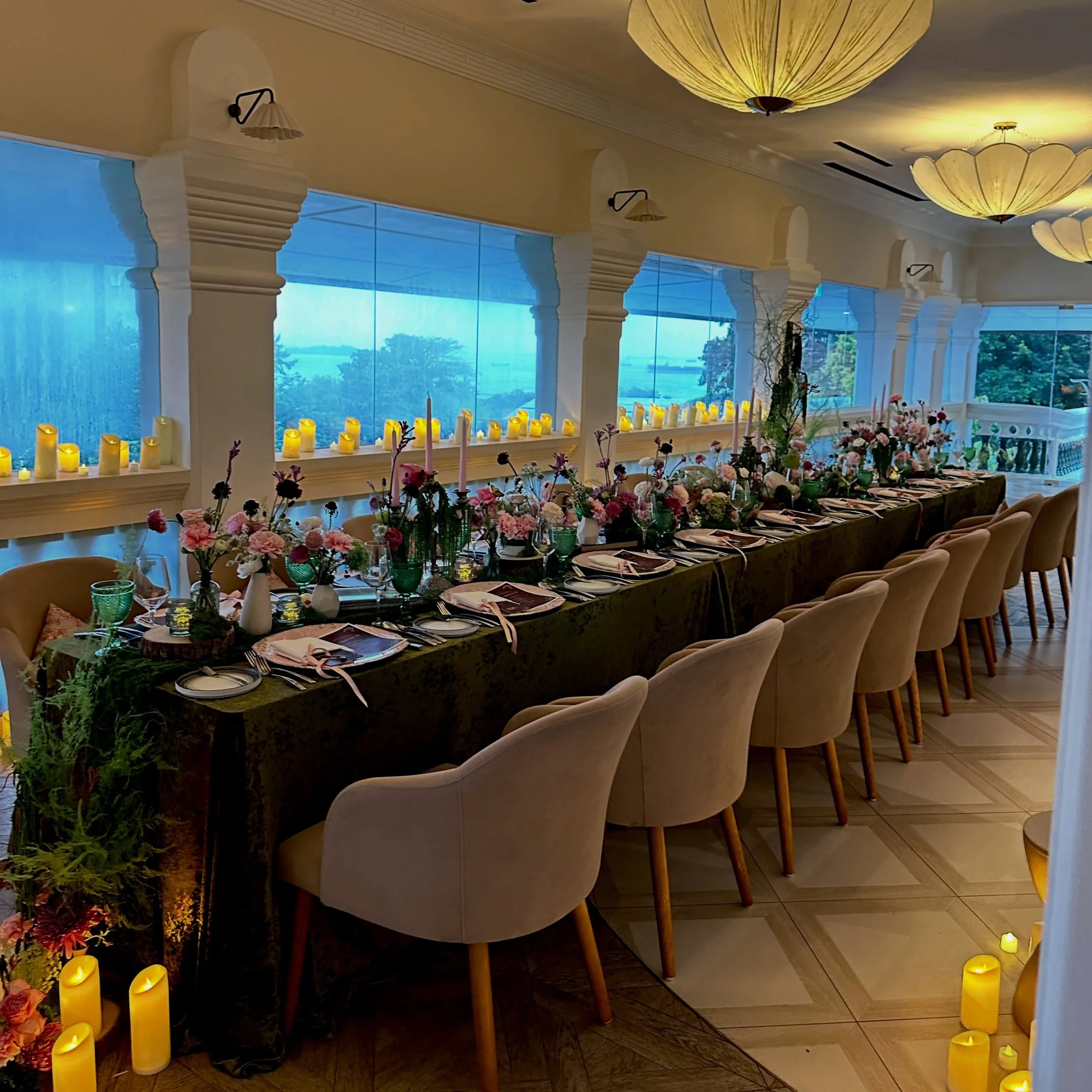 For our very stylish client&rsquo;s Chapter 40, guests stepped into an enchanting yet mysterious setting inspired by a murder mystery in a midnight garden. Moss-covered tables, candlelit pathways, cascading greenery, and romantic florals set the scen