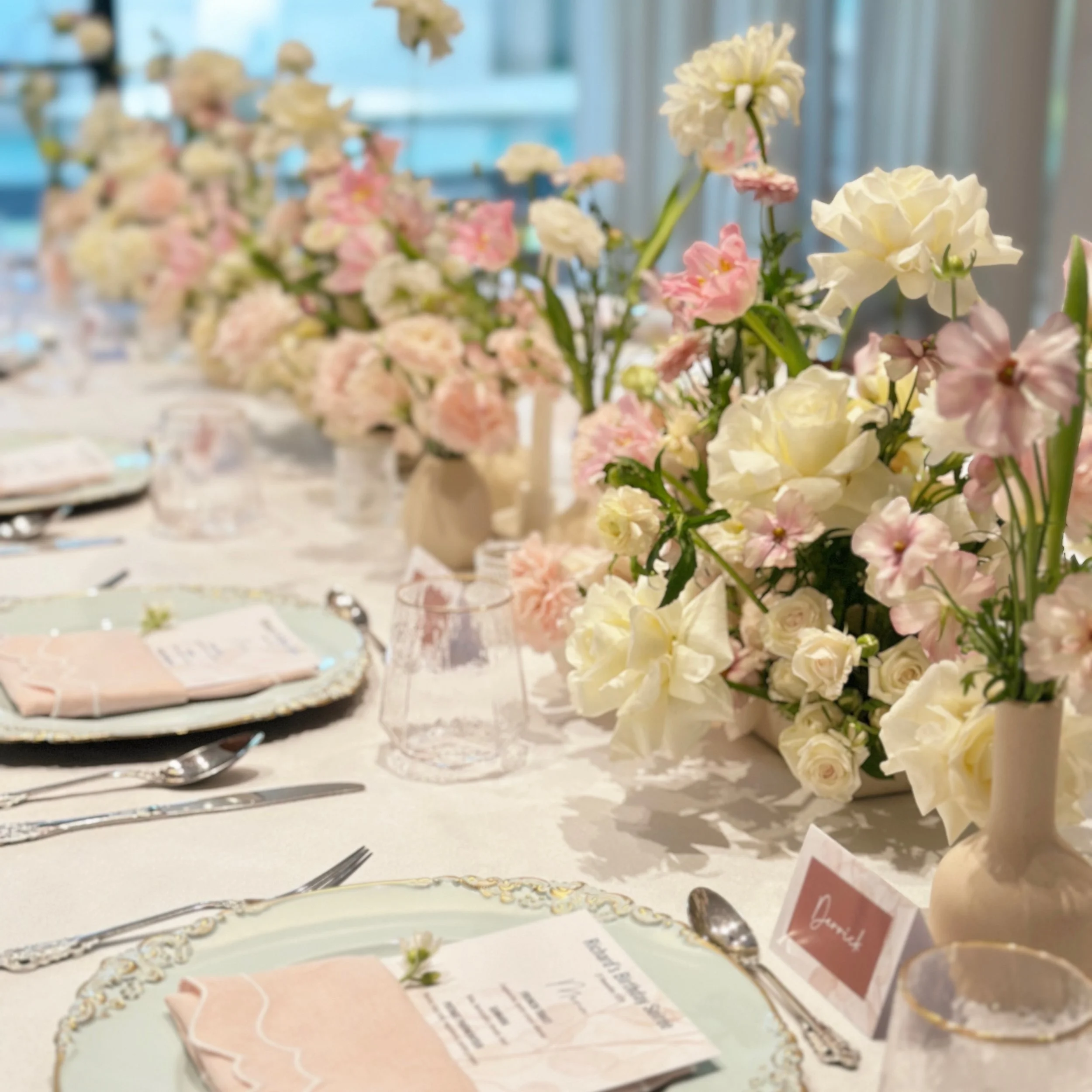 A clean and understated tablescape designed for an intimate birthday celebration.

Featuring a soft palette of blush and ivory florals, paired with classic table settings and personalised stationery, the setup was created to complement the space whil