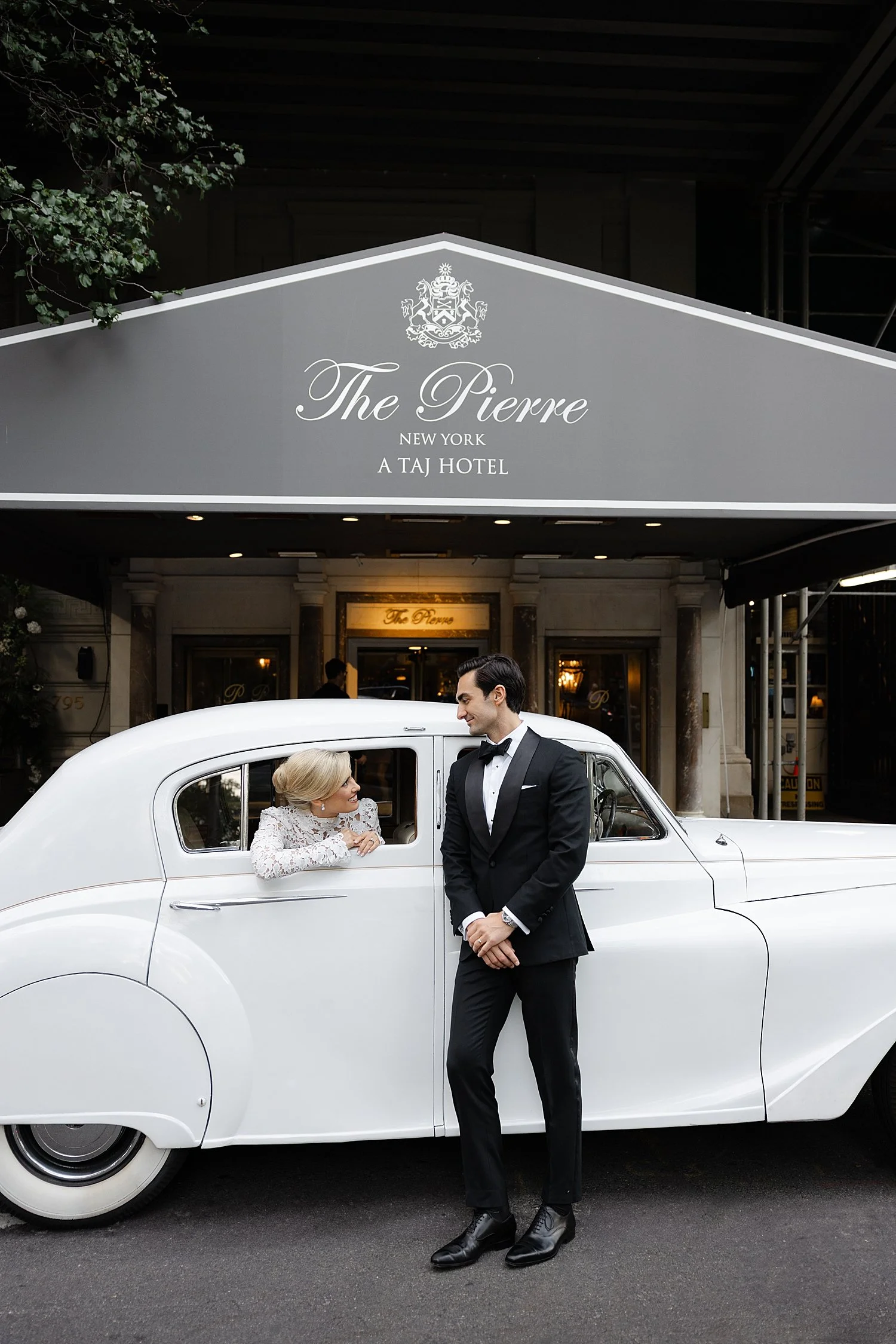  bride in backseat of classic car with groom  