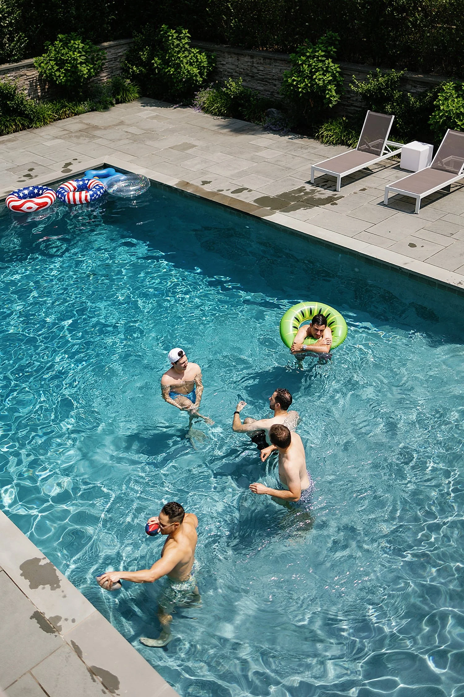  groom and groomsmen enjoy the pool 