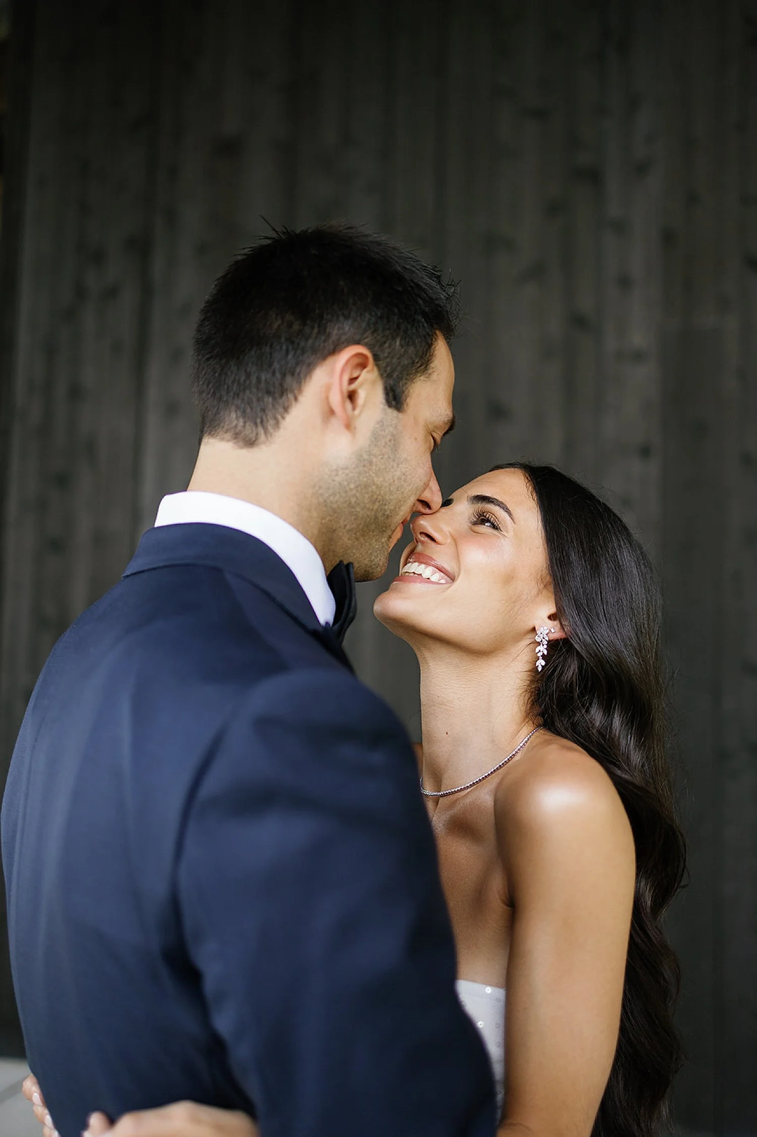  bride and groom lean together  