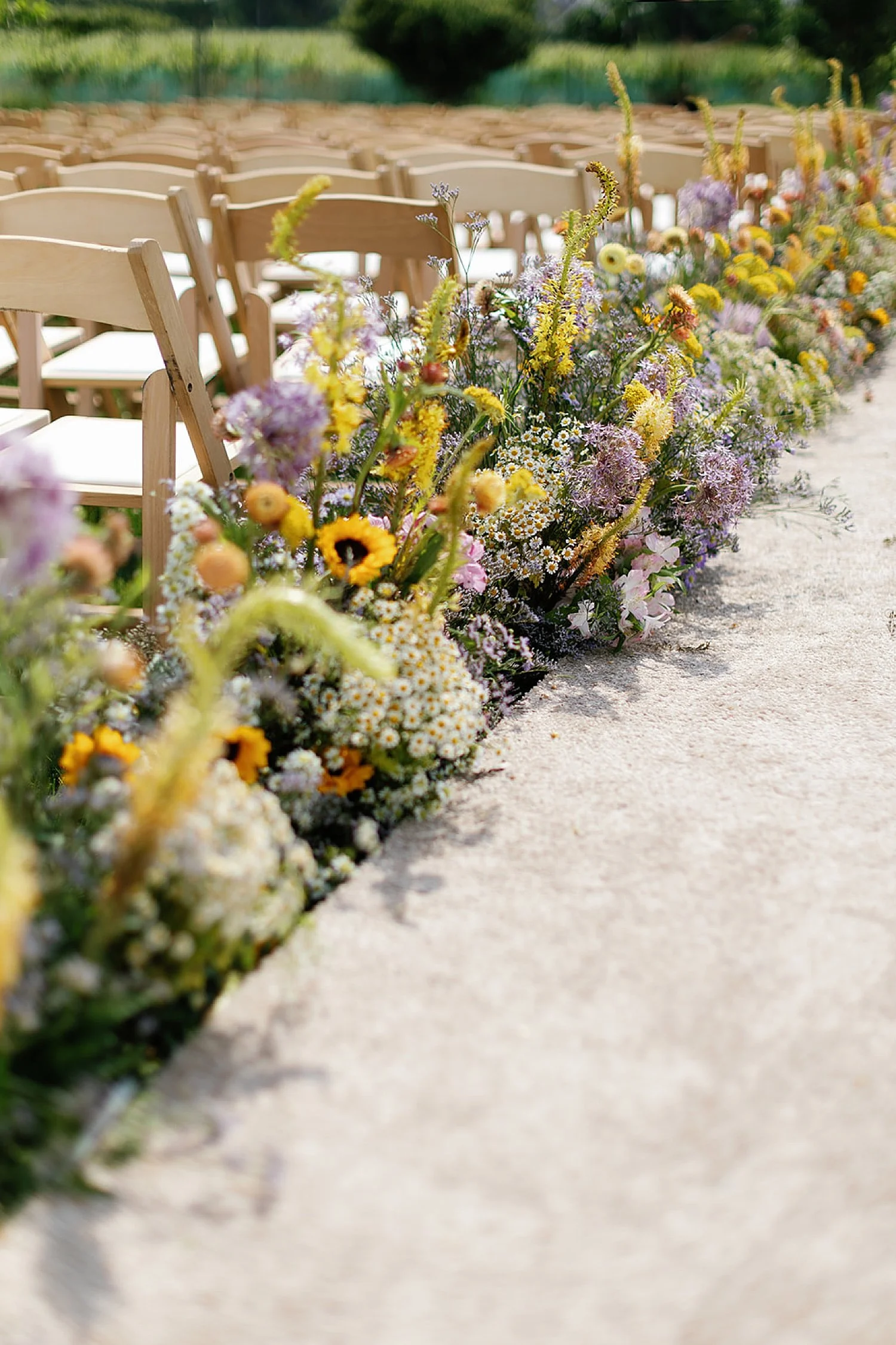  flower arrangement line the aisle at ceremony  