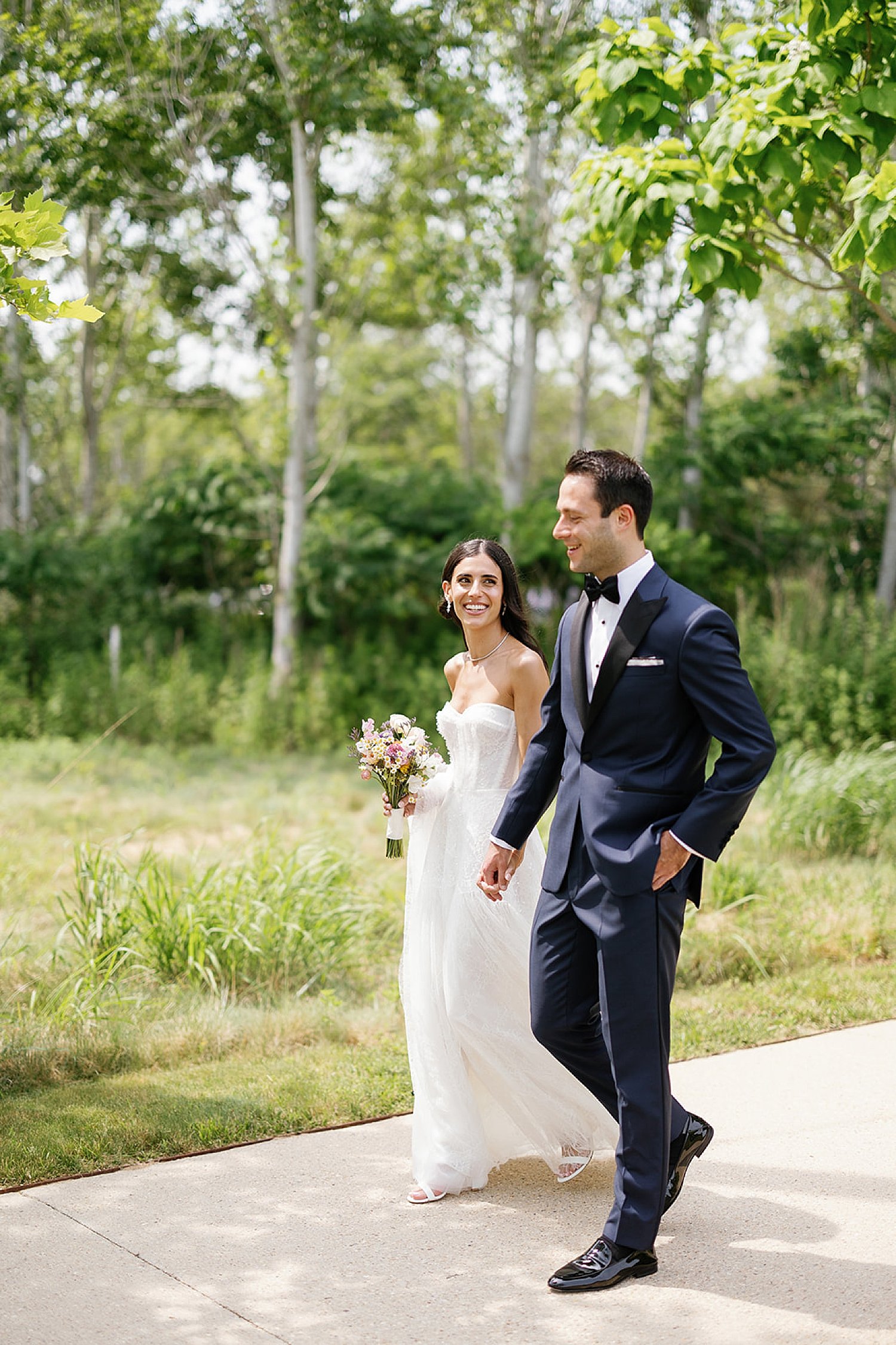  bride and groom walk together 