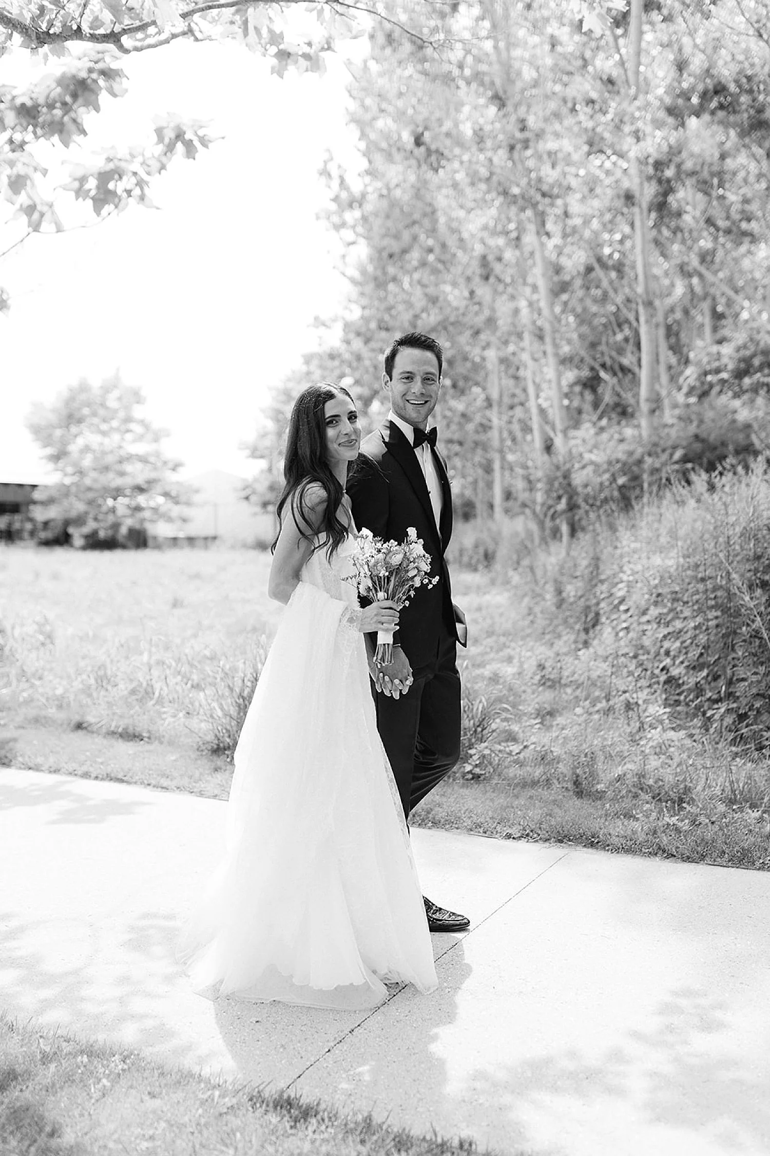  bride and groom walk together outside of Parrish Art Museum  