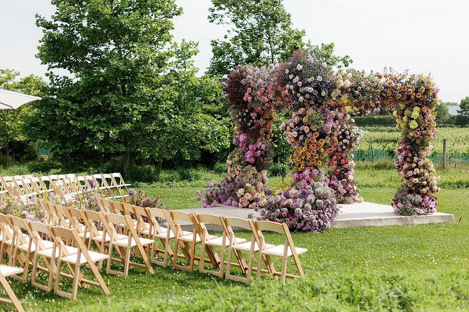  Timeless summer wedding ceremony in the Hamptons with colorful flowers decorating chuppah  