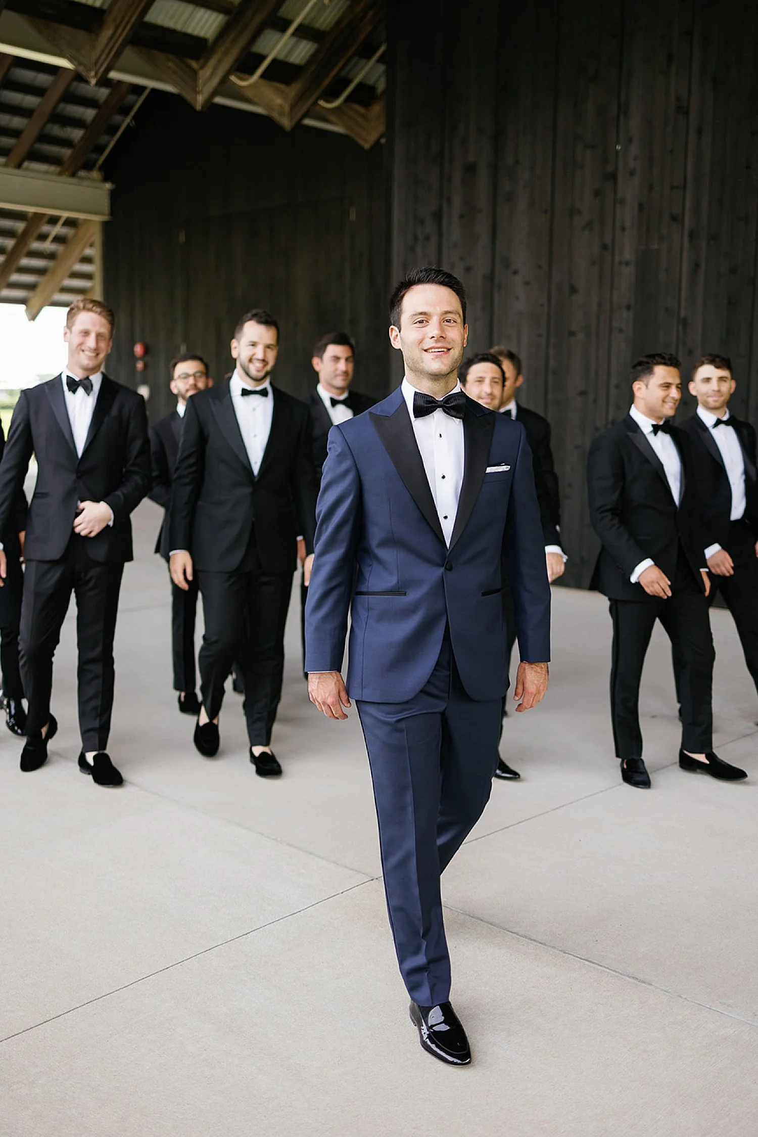  groom walking with groomsmen 