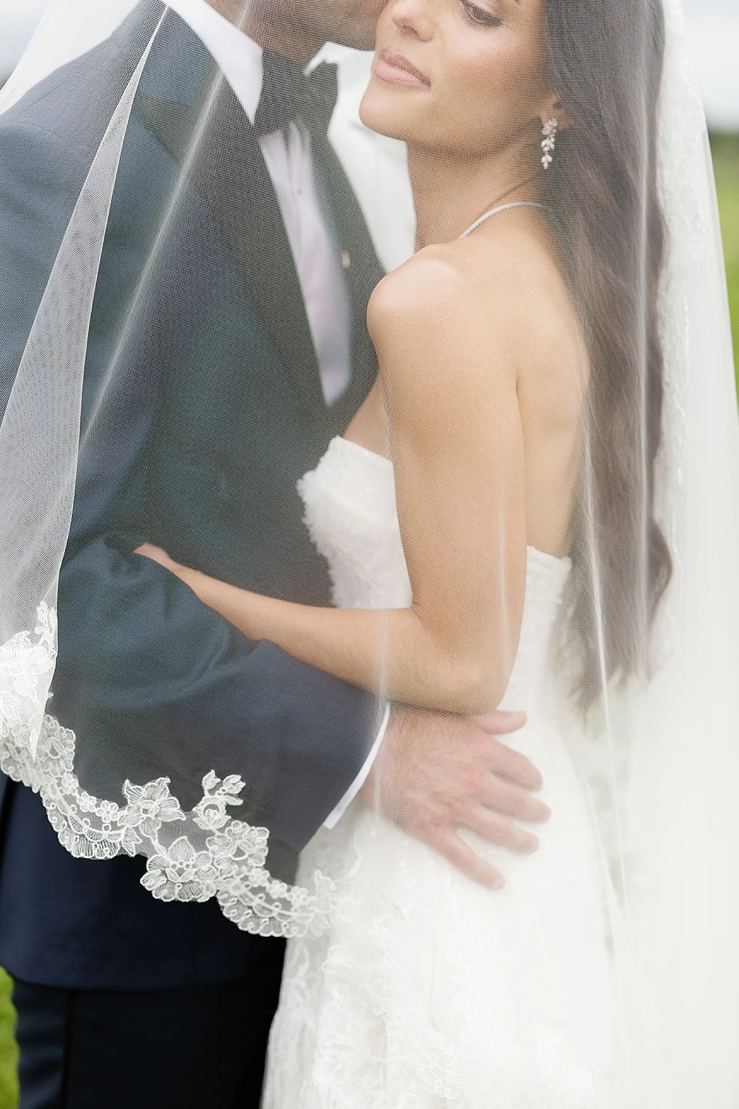  wedding photos of couple under bride’s veil 