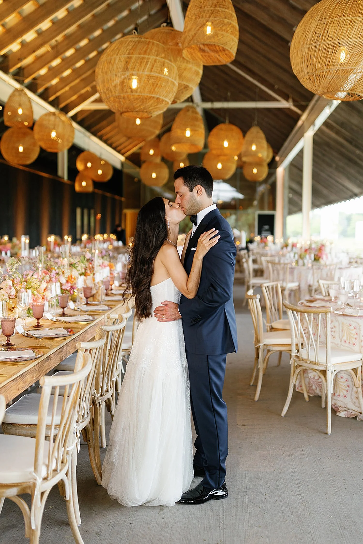  newlyweds kiss in reception space  