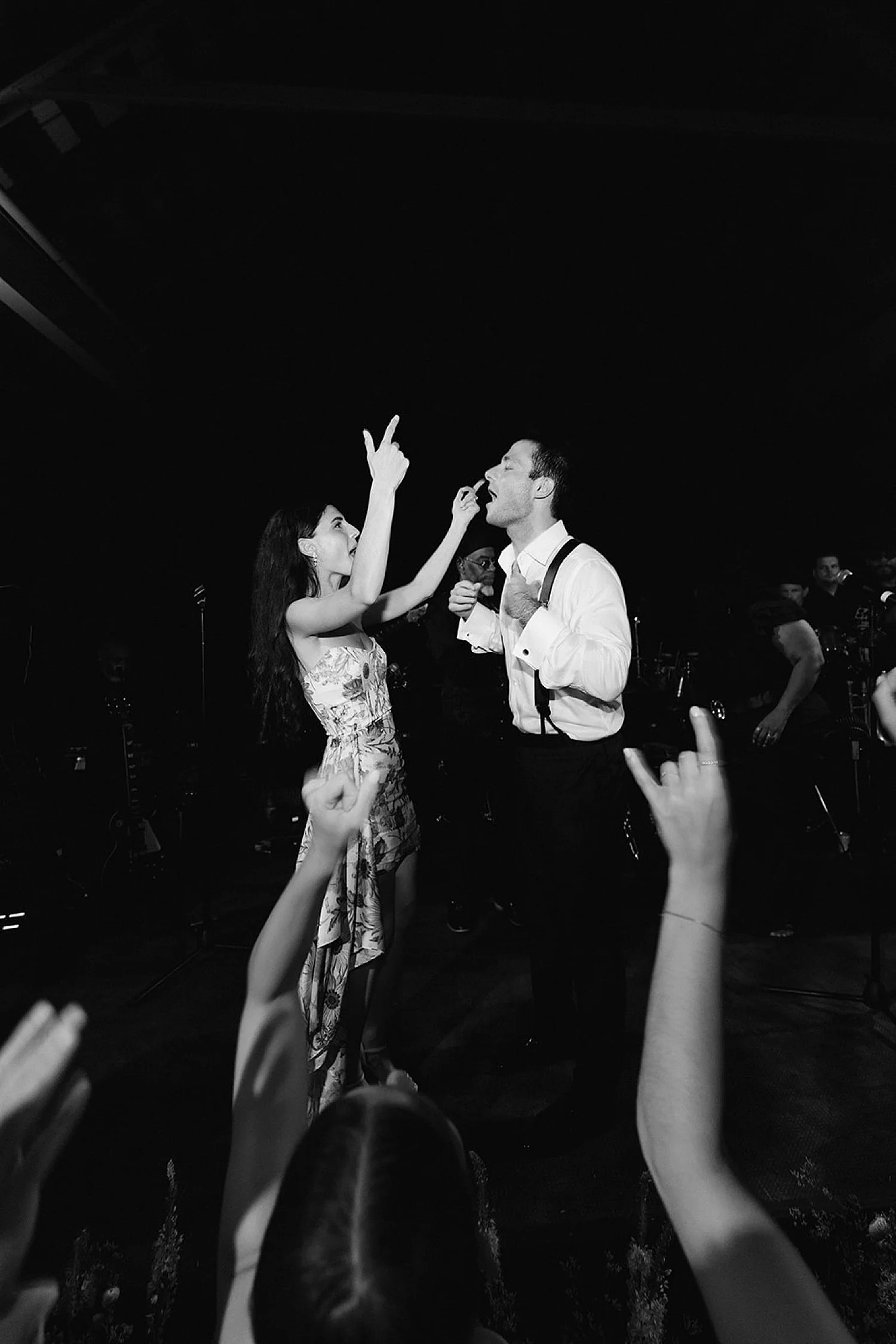 newlyweds on stage at summer wedding reception  