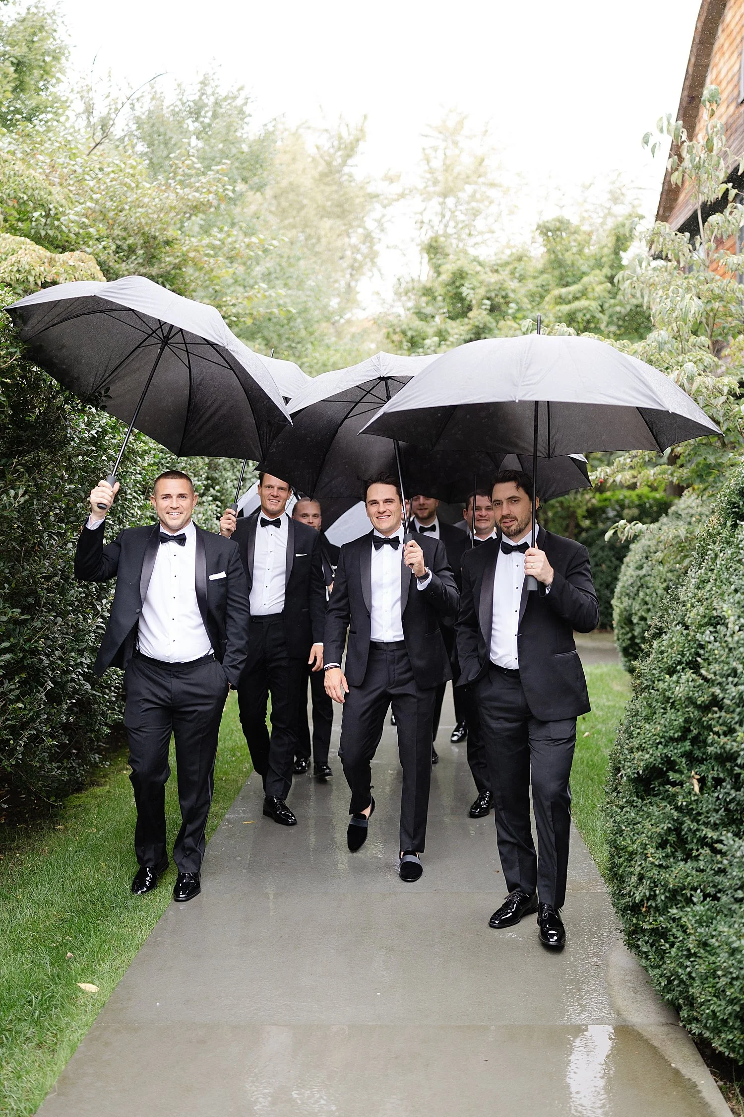  groom and groomsmen portraits in the rain  