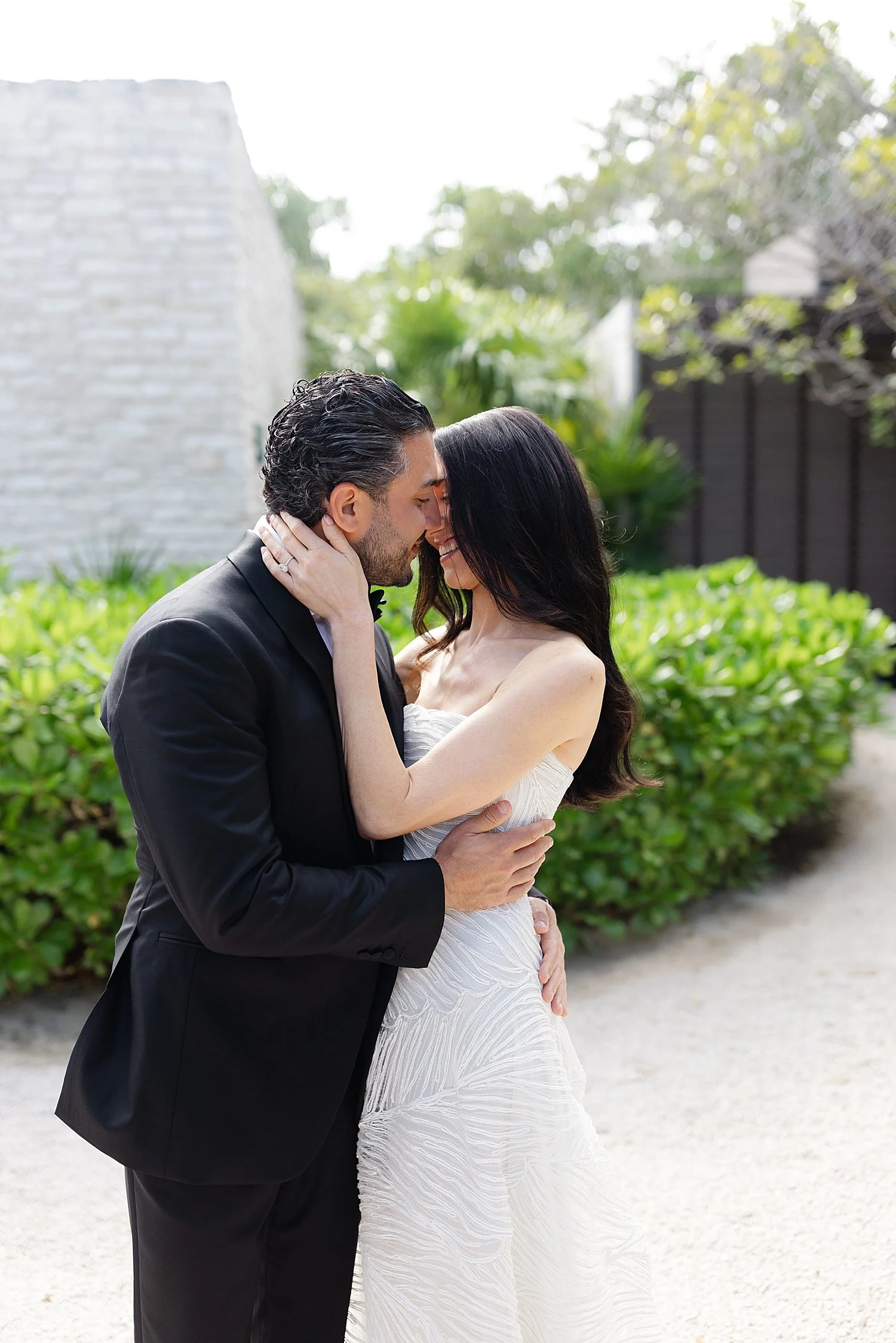  bride and groom lean in to each other during first look 