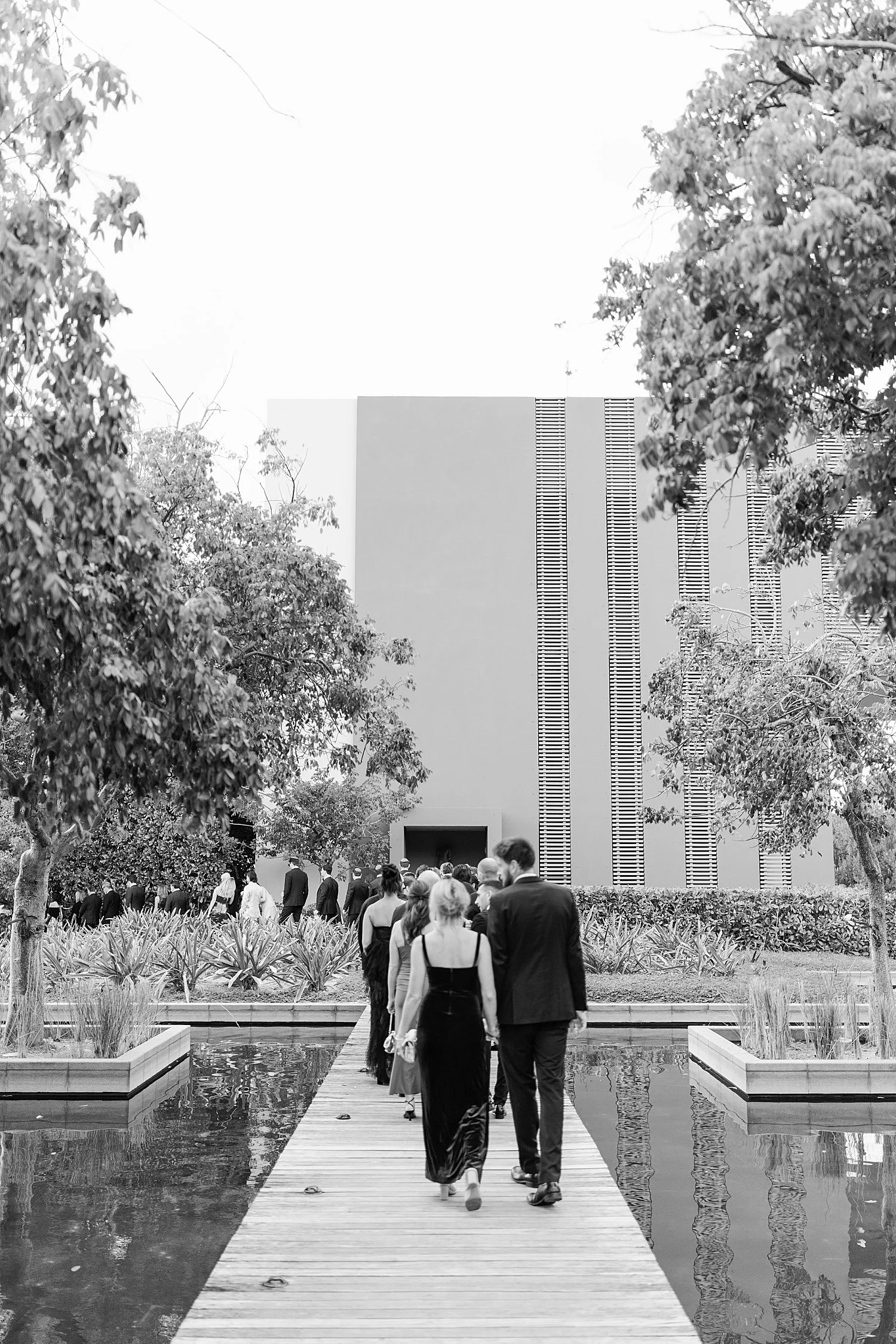  wedding guests walk to wedding ceremony  