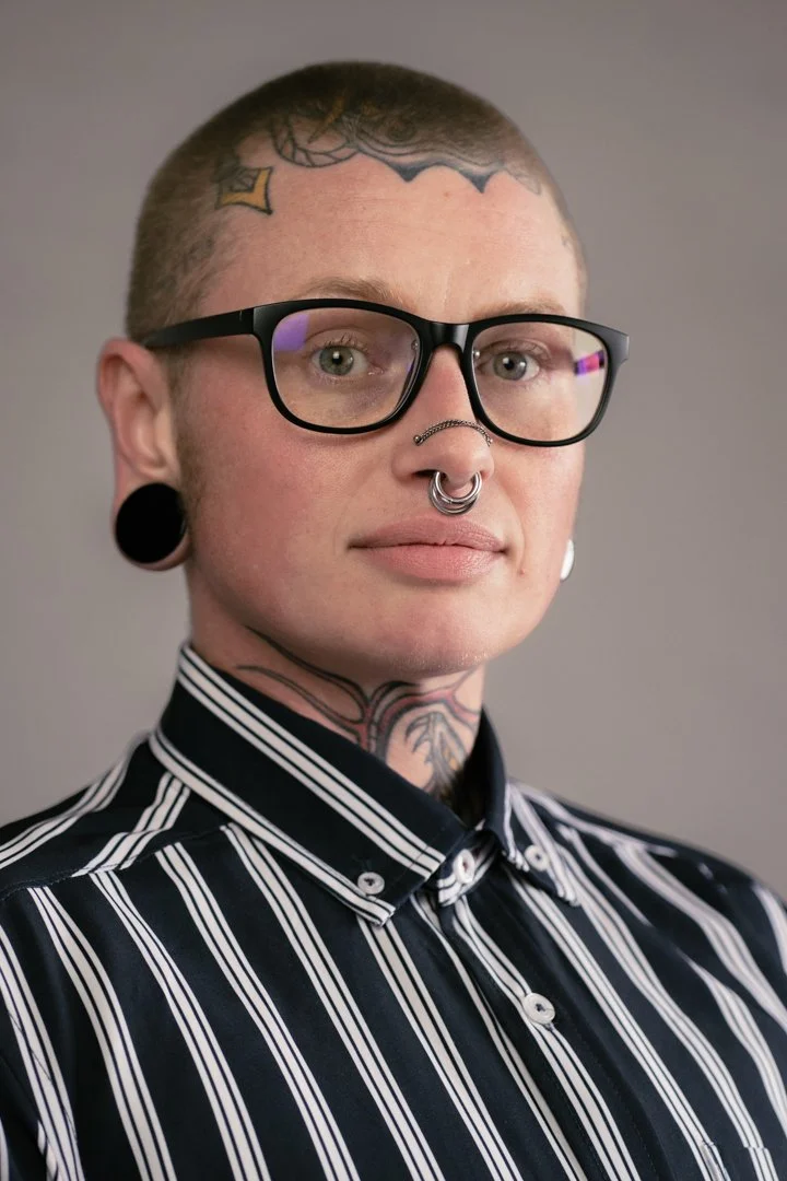 headshot of sloan in striped shirt