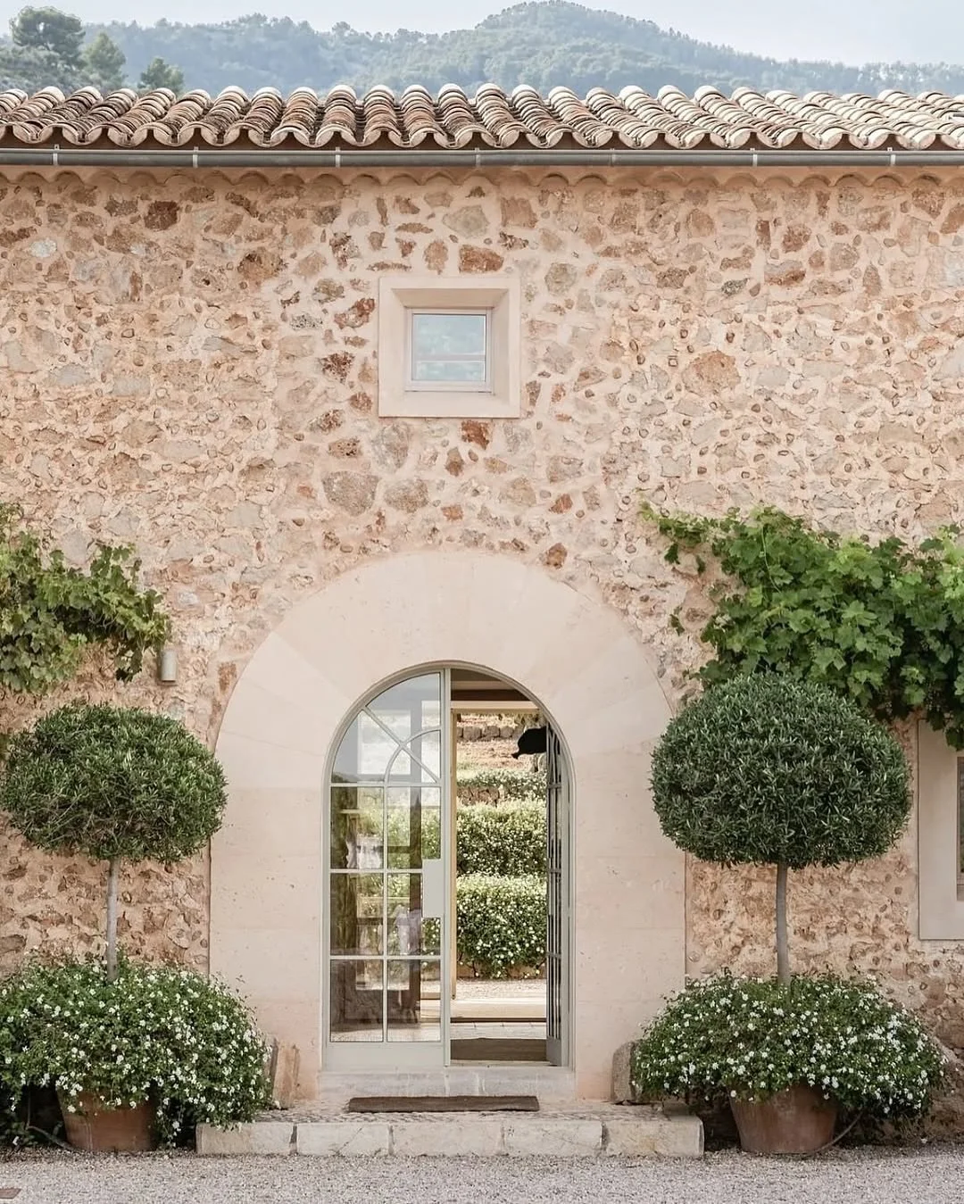 In love with the rustic charm of this arched entrance!