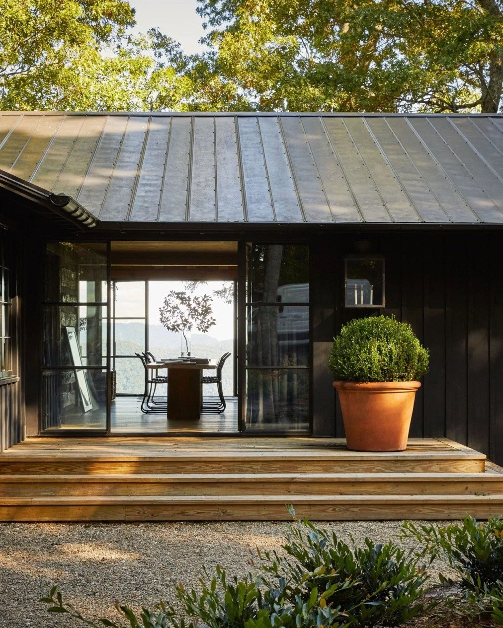 // Betsy&rsquo;s Cabin //

"Originally built in the 1960s, the cabin is located on the Green River in the Blue Ridge Mountains in North Carolina. There is an elegance to how the form sits recessively in the landscape, cloaked in black-toned meta