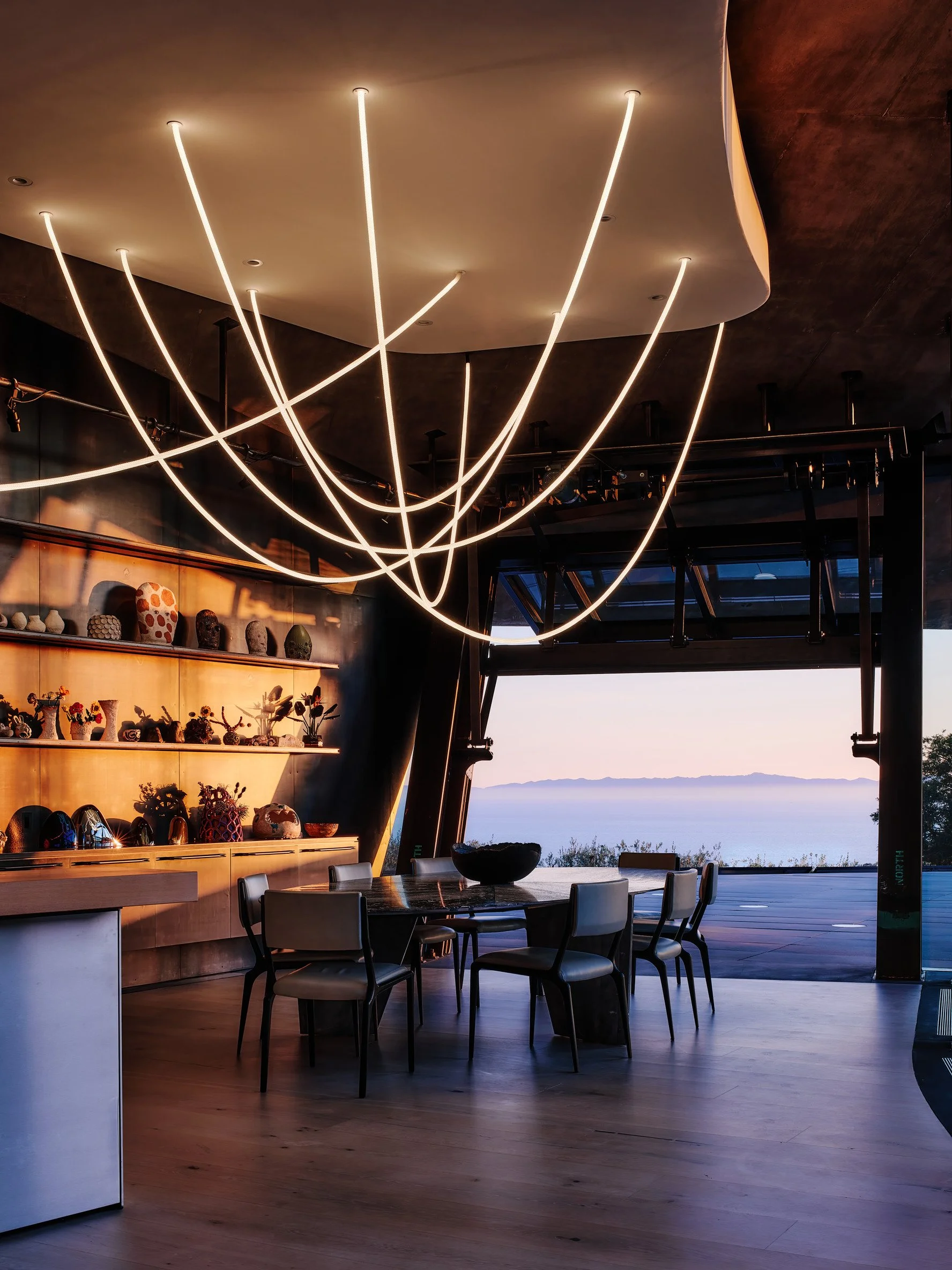Image of lighting rods over a dining table overlooking the mountains