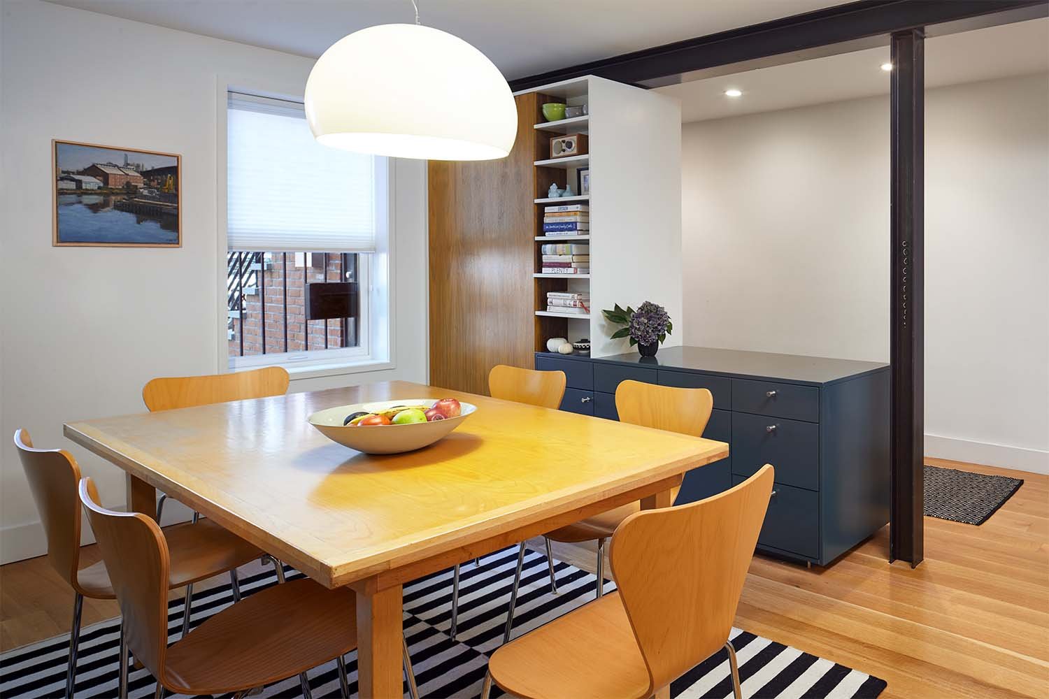 …acting as a sideboard to the dining area. Like a Chinese puzzle, it has cavities that are full-depth from either side and others that split it in half.