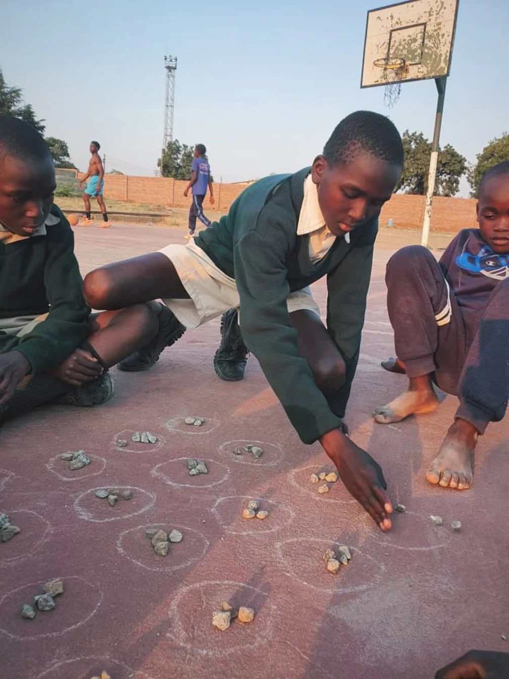 Kids play a local game called Tsoro on our courts in addition to basketball to keep their heads in the game! #zimbabwe #hoops4hope #gametime #focus