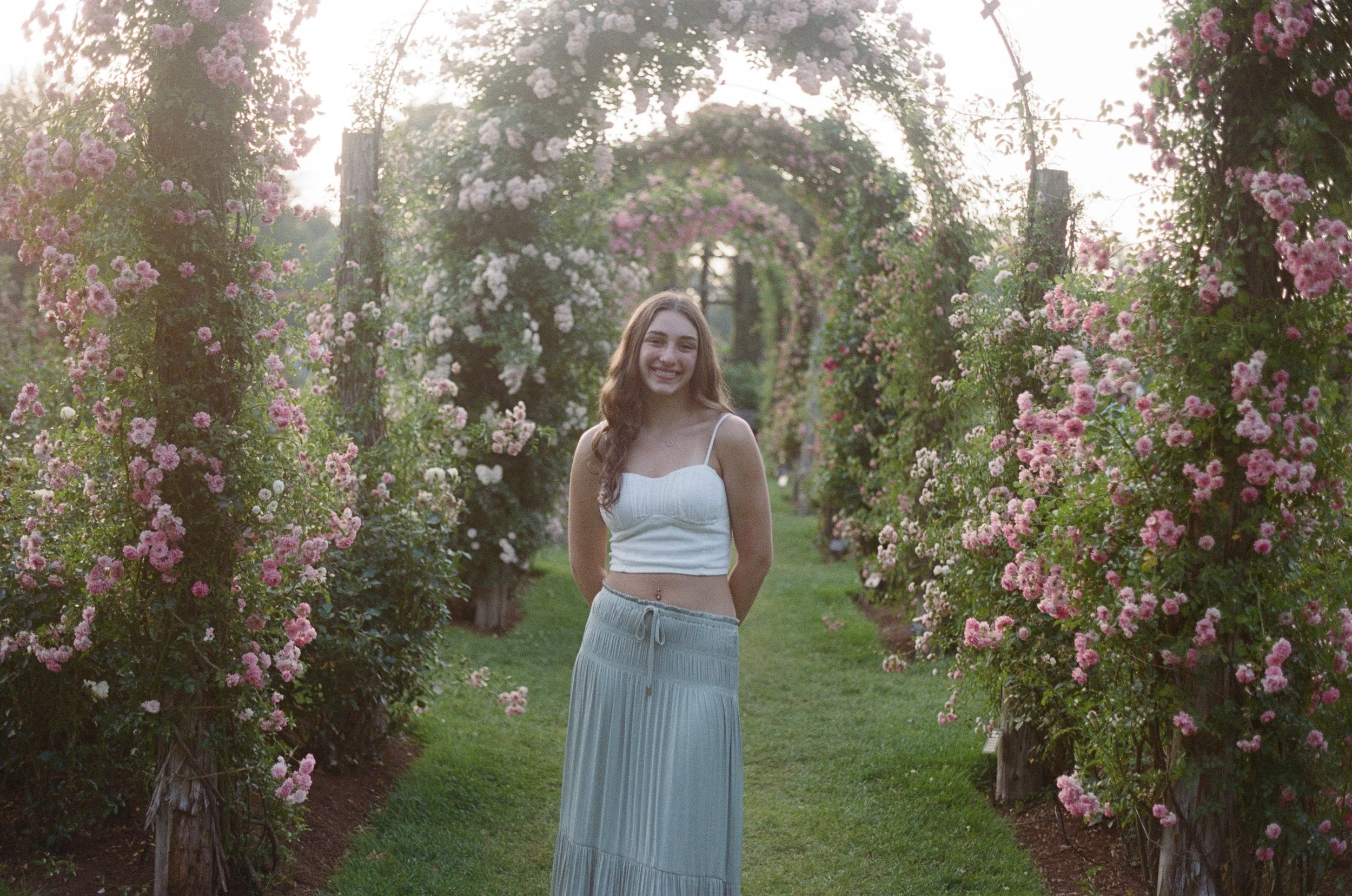 Photo of a girl standing in Elizabeth Park Rose Garden in CT by Briana Raucci, CT film wedding photographer