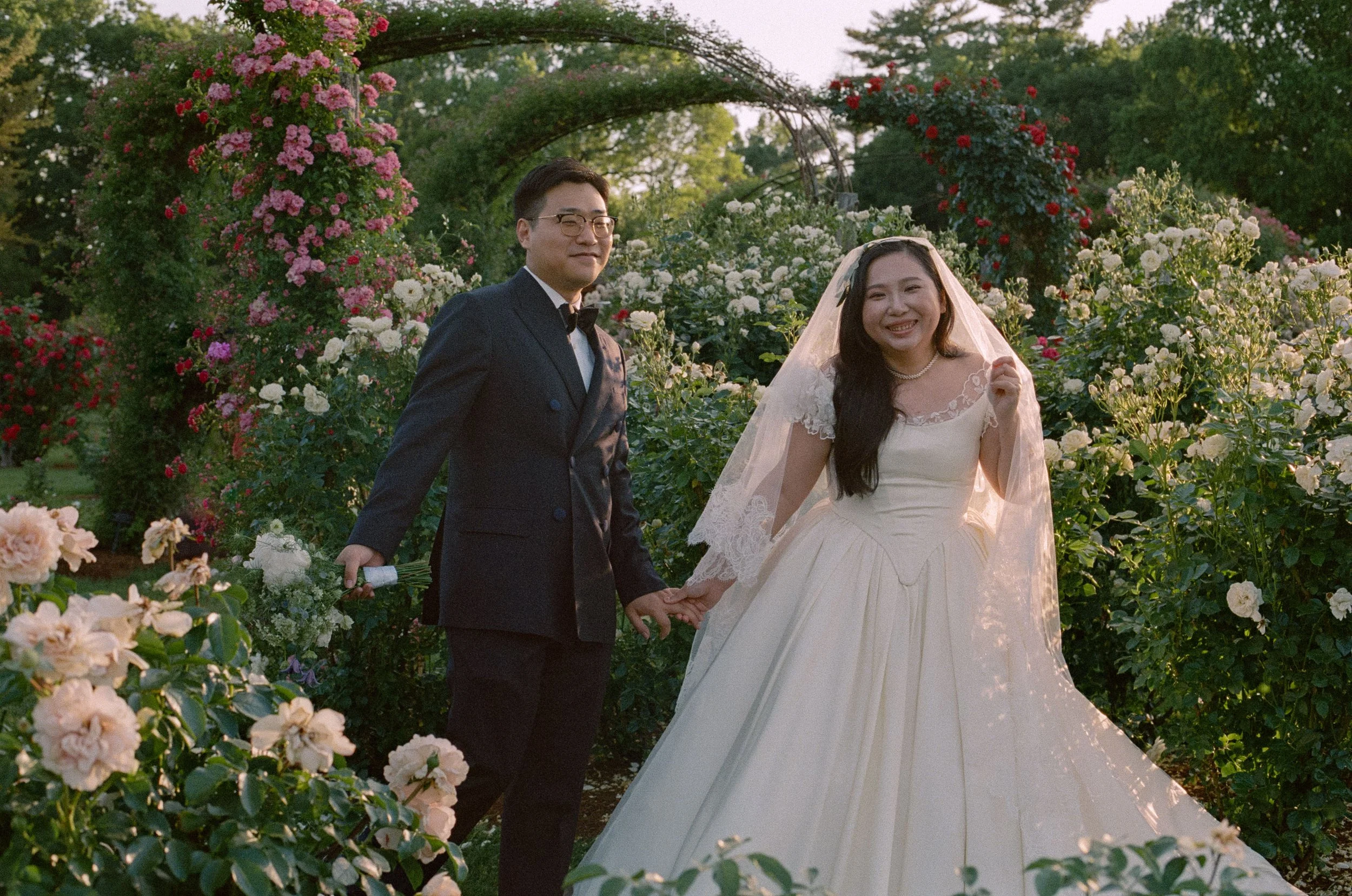 Chinese wedding at Elizabeth Park Rose Garden. Rose Garden elopement on film by CT wedding photographer Briana Raucci. Couple in rose garden in princess wedding dress