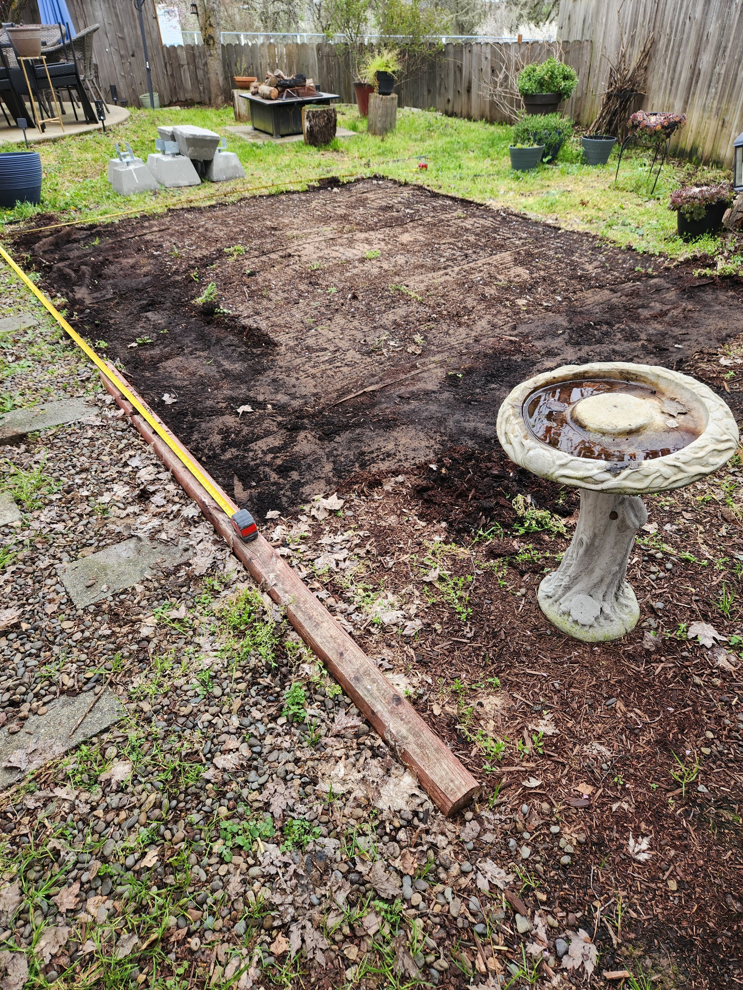 A backyard area prepped for new wooden patio to be built