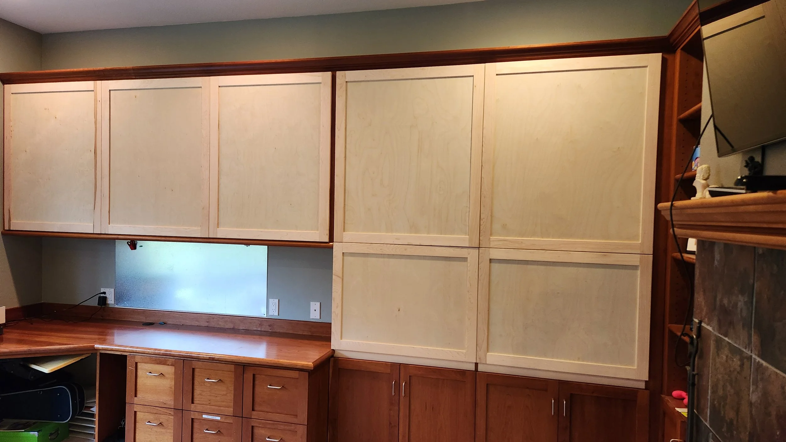 View of a office with wooden cabinets and newly built doors for the shelves