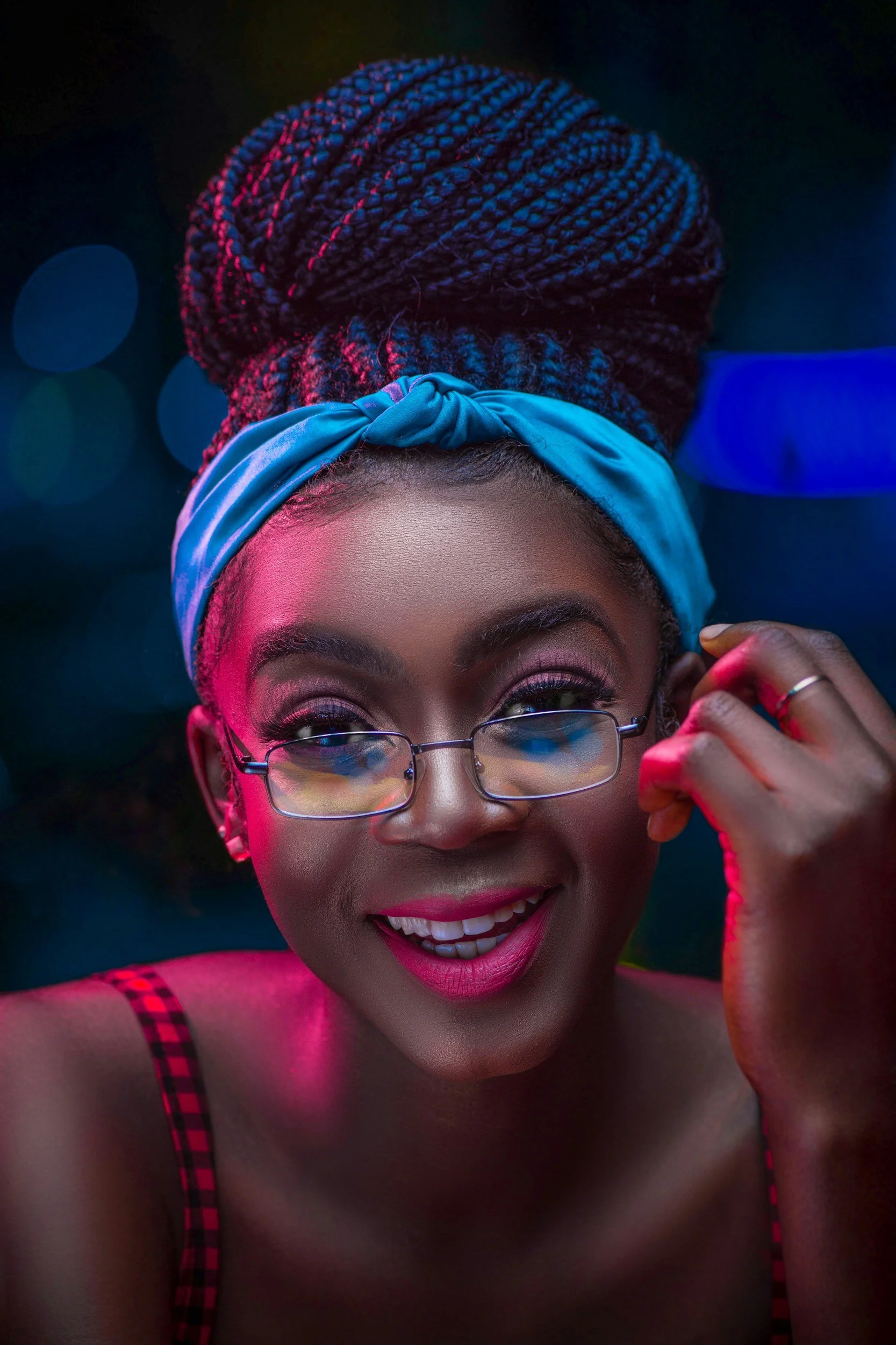 Nerdy girl with braided hair, a blue headband, and glasses