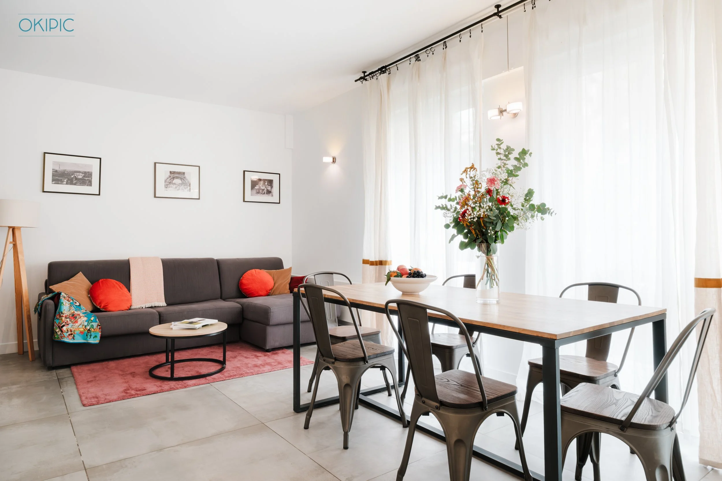 Bright, airy living-dining space with sofa and table for six.