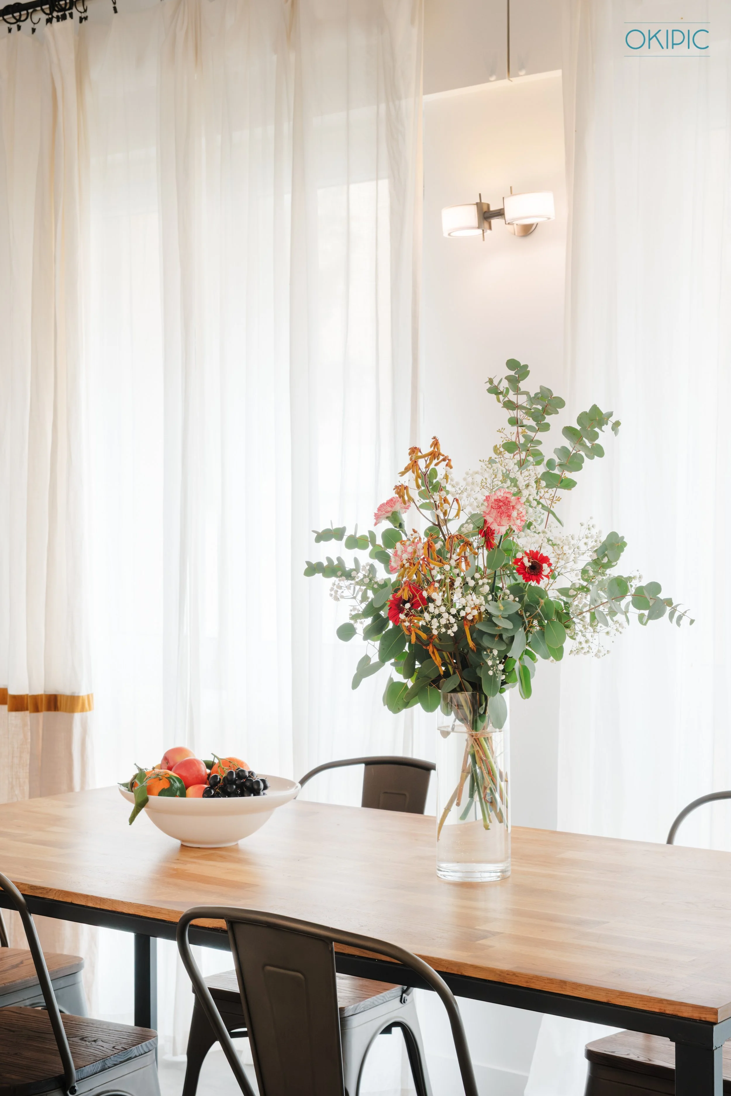 Sunlit dining table. A stylish spot for meals or work.