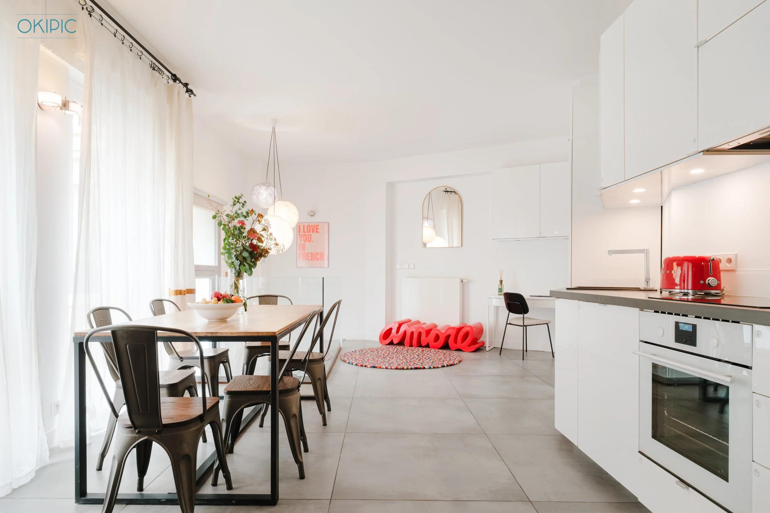 Bright open-plan kitchen with modern appliances and dining for six.