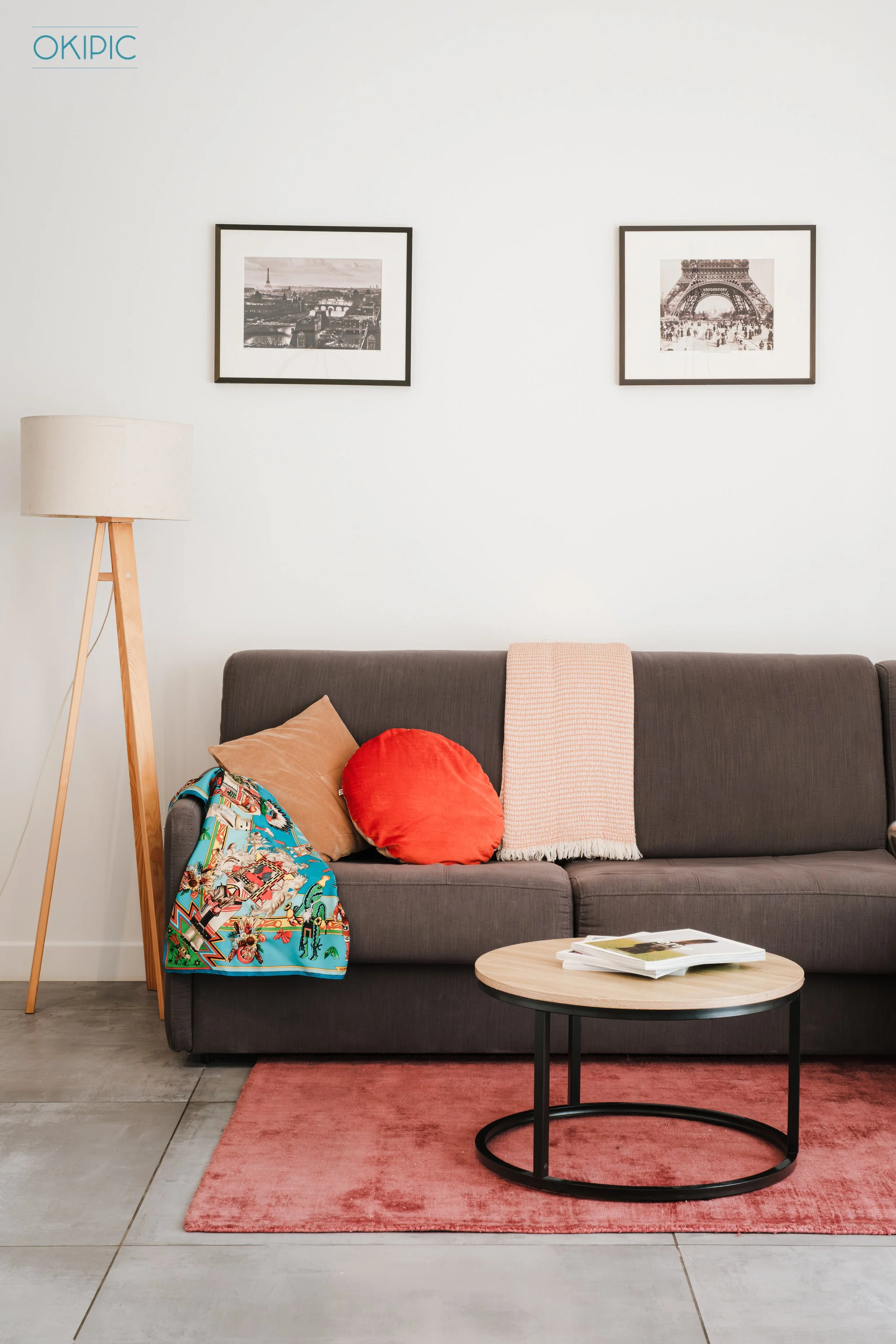 Bright, modern lounge with comfy sofa, artful touches, and cozy rug.