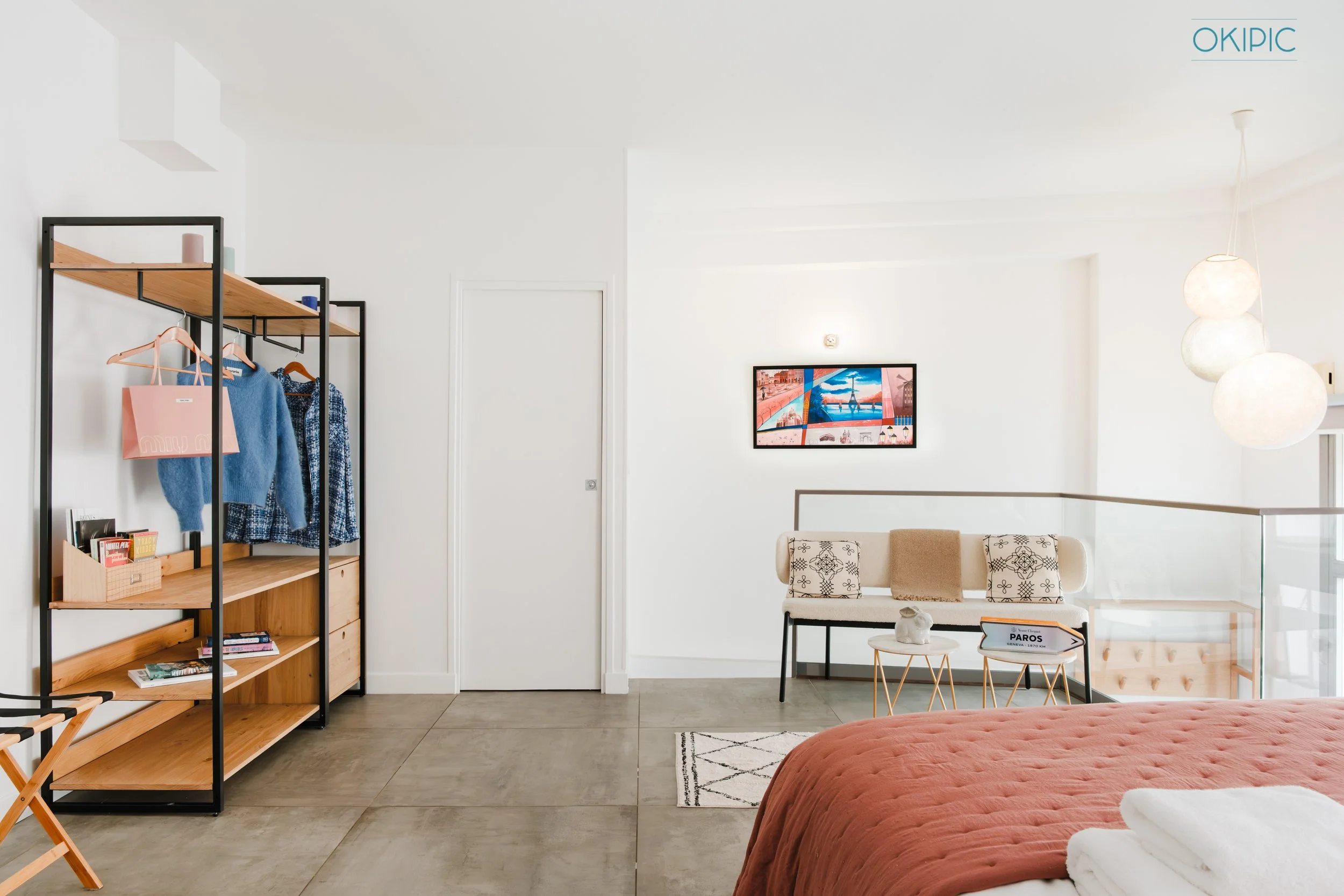 Bright bedroom (1) with cozy bed, open wardrobe, and chic lounge nook.