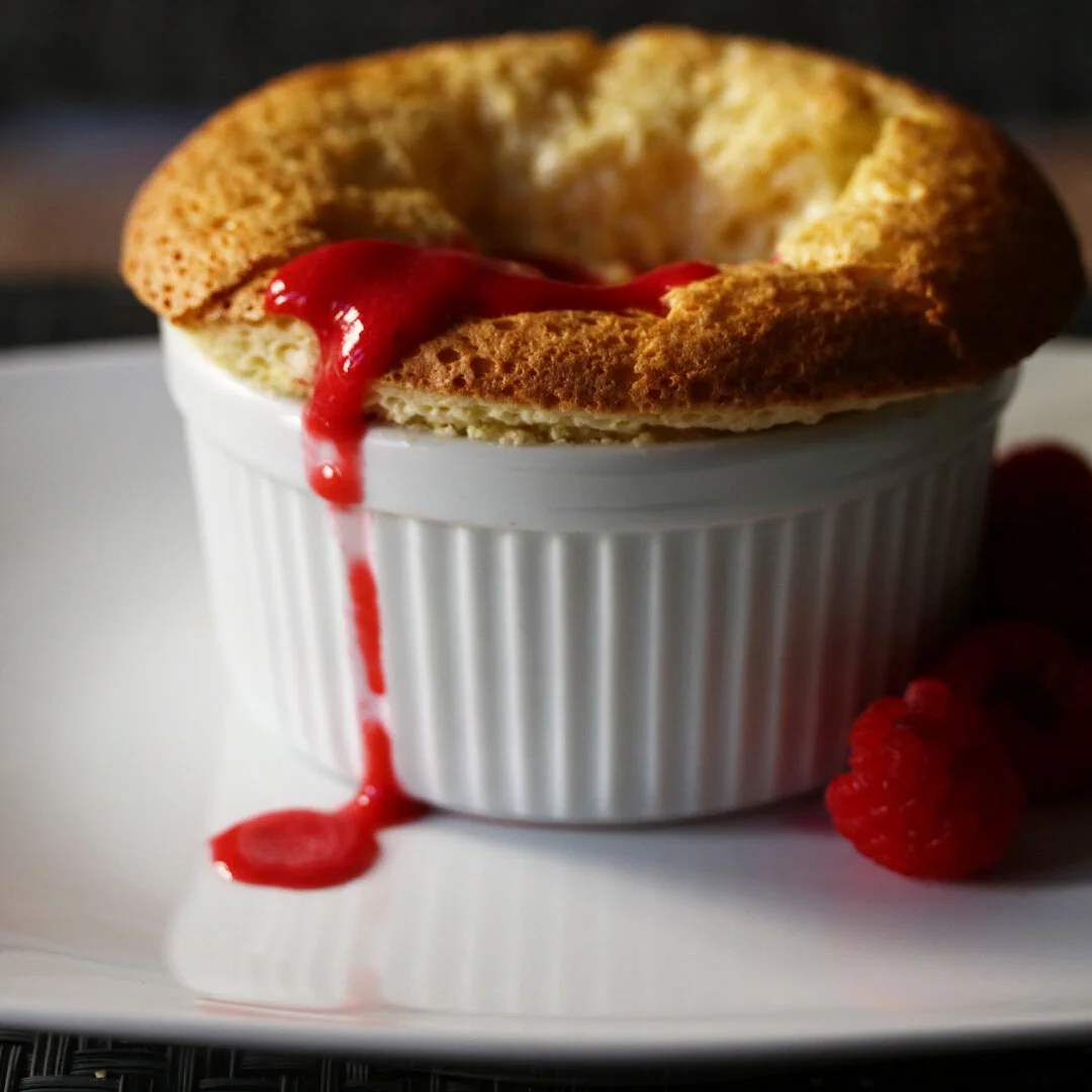 White chocolate soufflé with a raspberry purée.jpeg